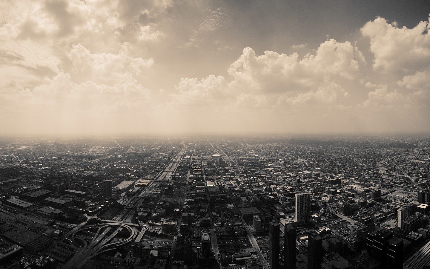 Sepia toned aerial view of Chicago cityscape with clouds HD Wallpaper