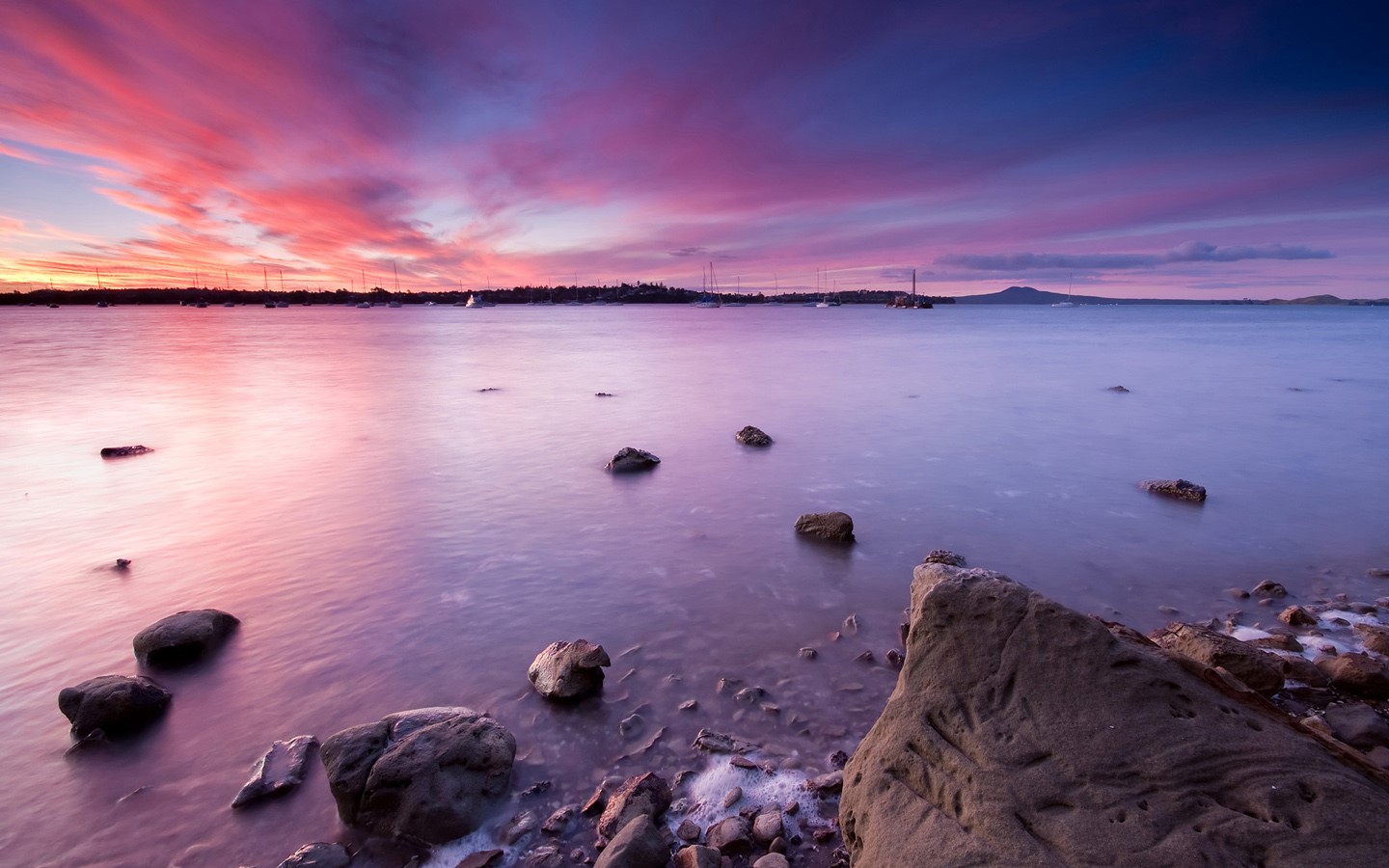 Sunset over a bay with boats and islands HD Wallpaper