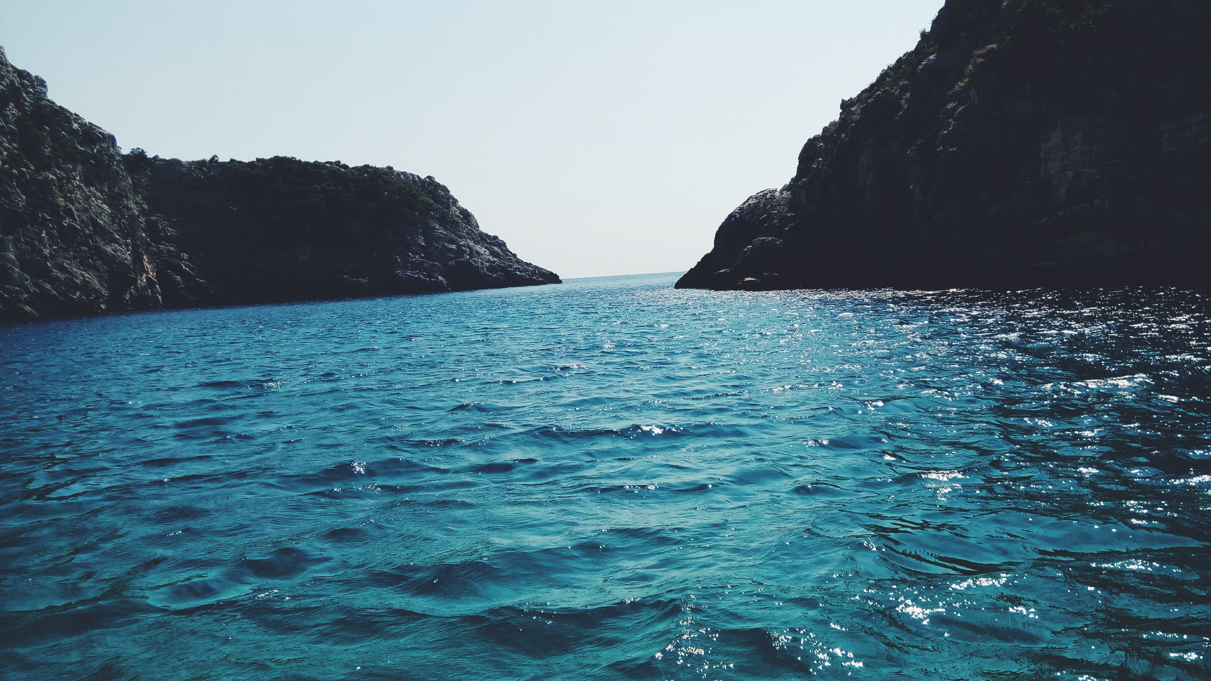4K sea and sky between rocky cliffs HD Wallpaper