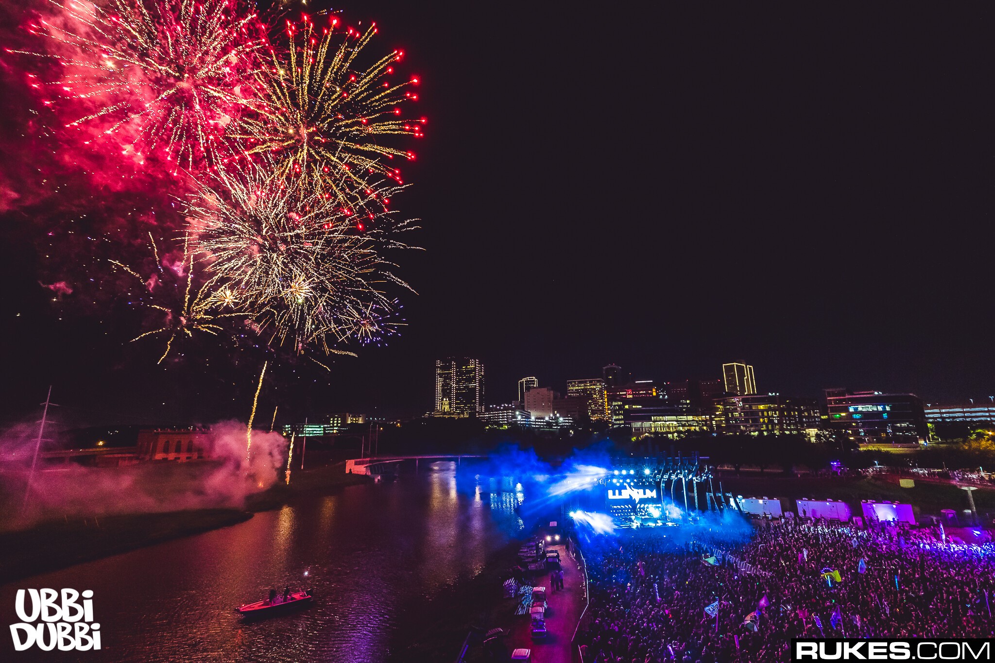 Fireworks over river and city skyline at night festival HD Wallpaper