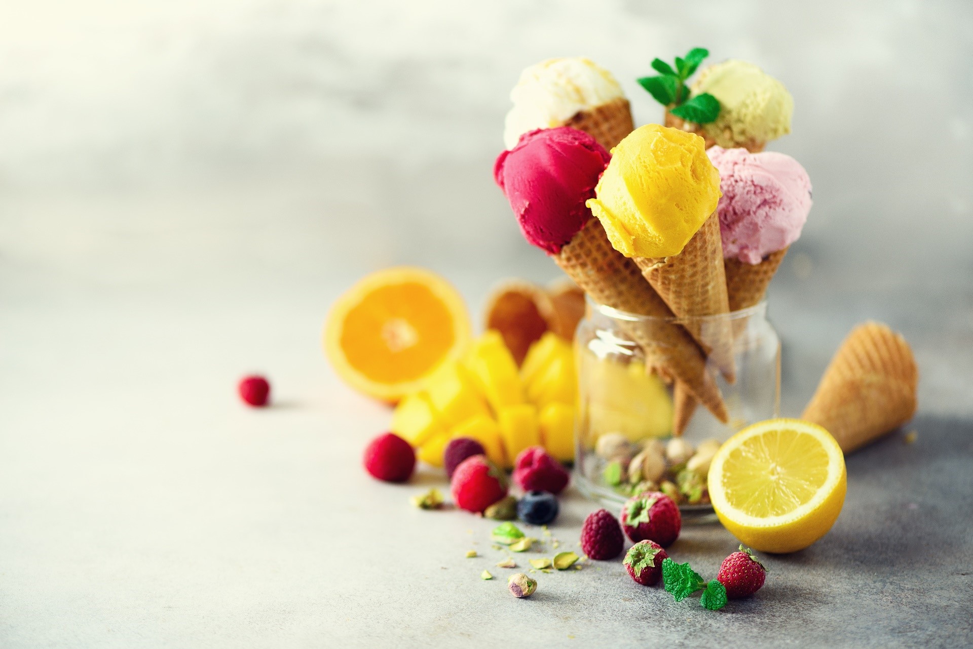 Assortment of ice cream cones with fruits and nuts HD Wallpaper