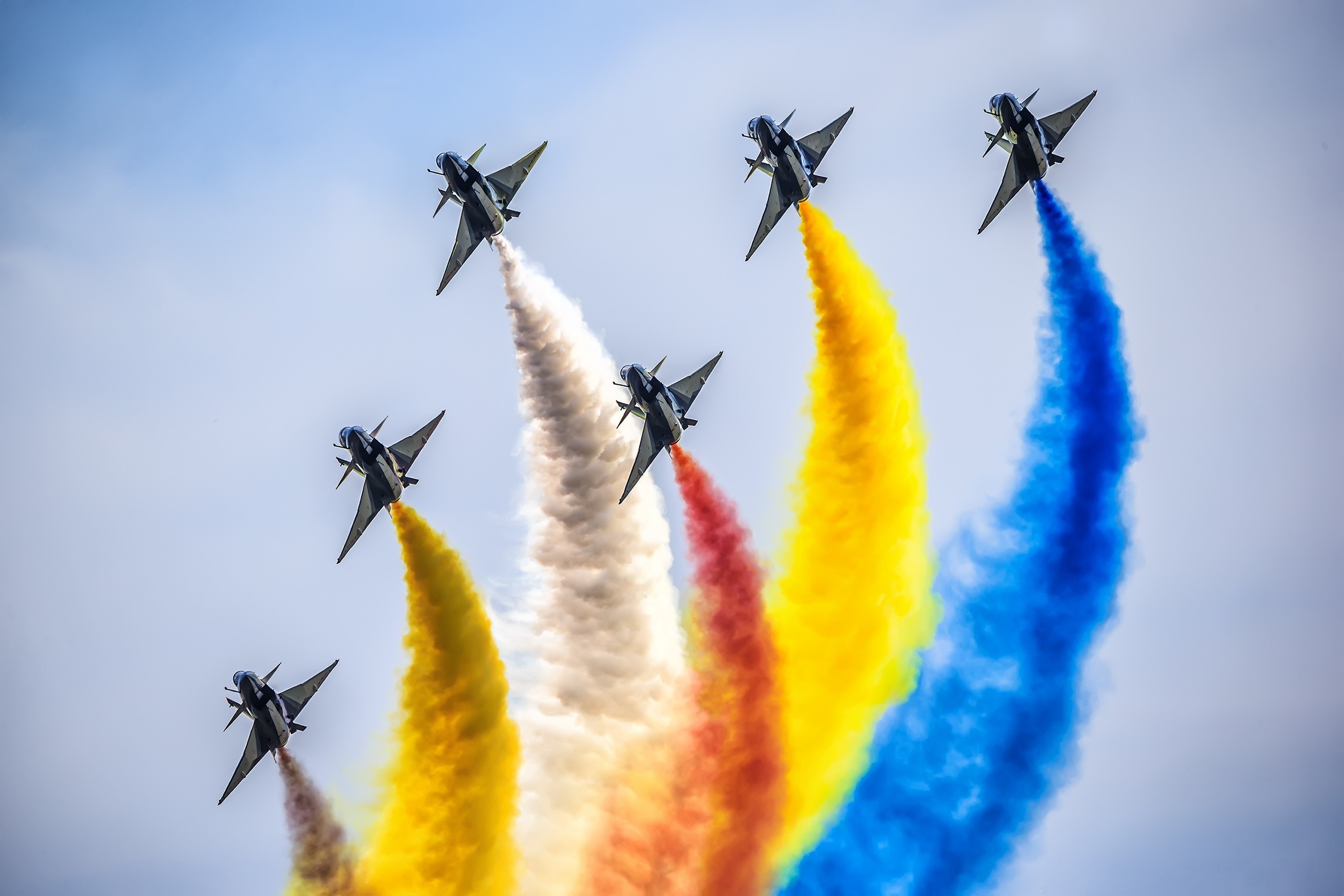 J-10 fighter jets perform aerobatics with colored smoke HD Wallpaper