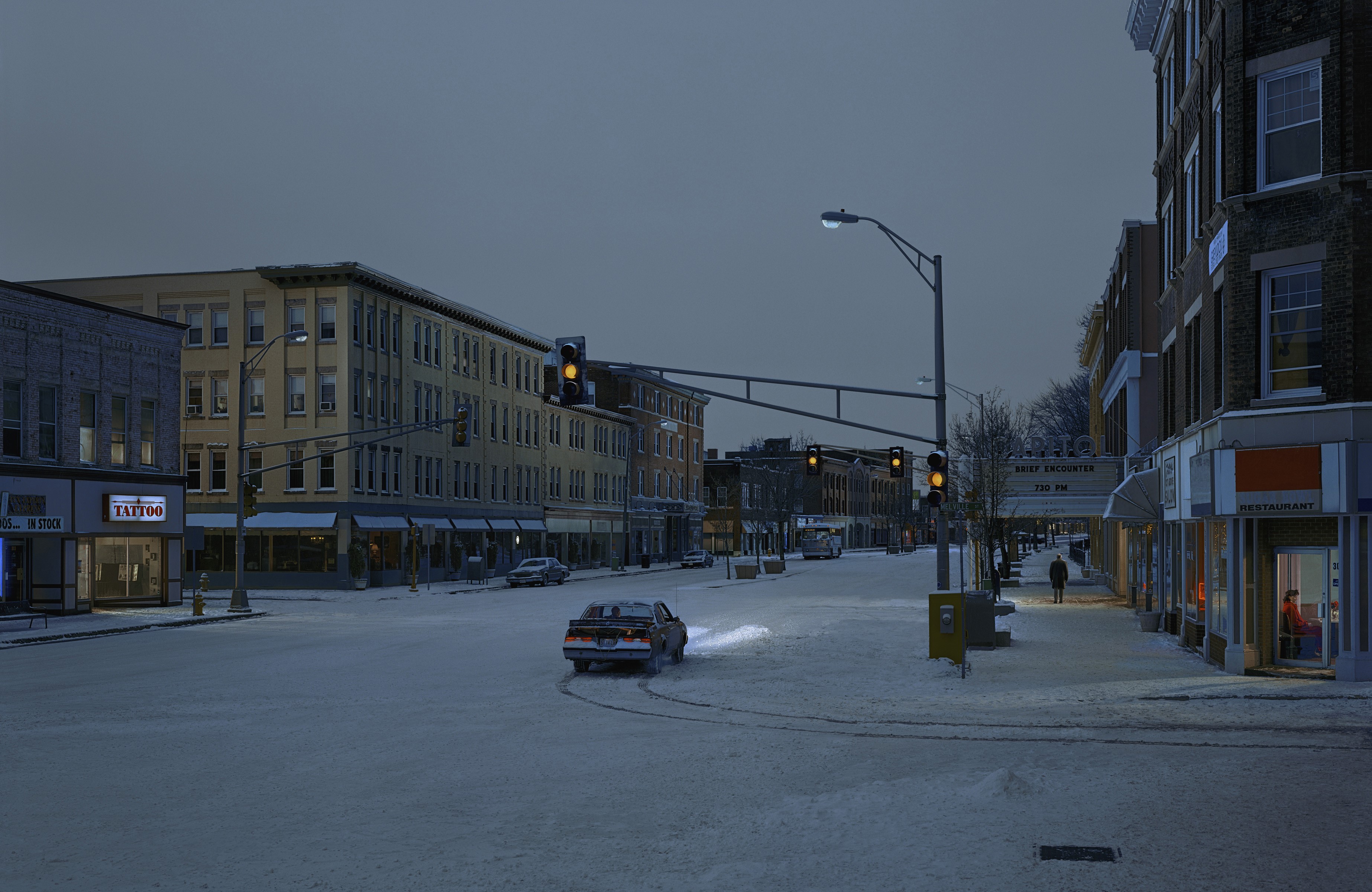 Snowy town street with traffic lights and cars HD Wallpaper