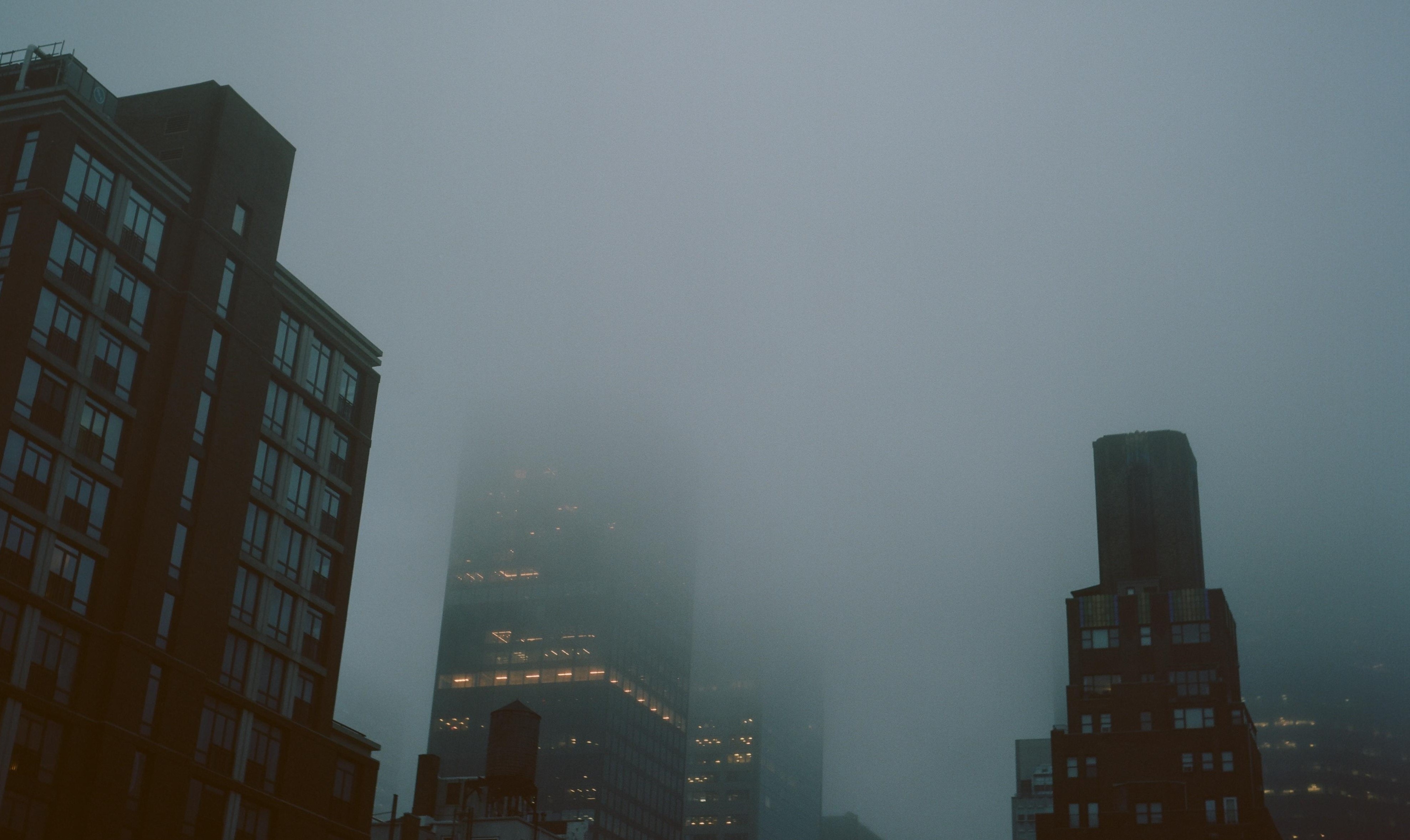 City skyscrapers shrouded in mist HD Wallpaper