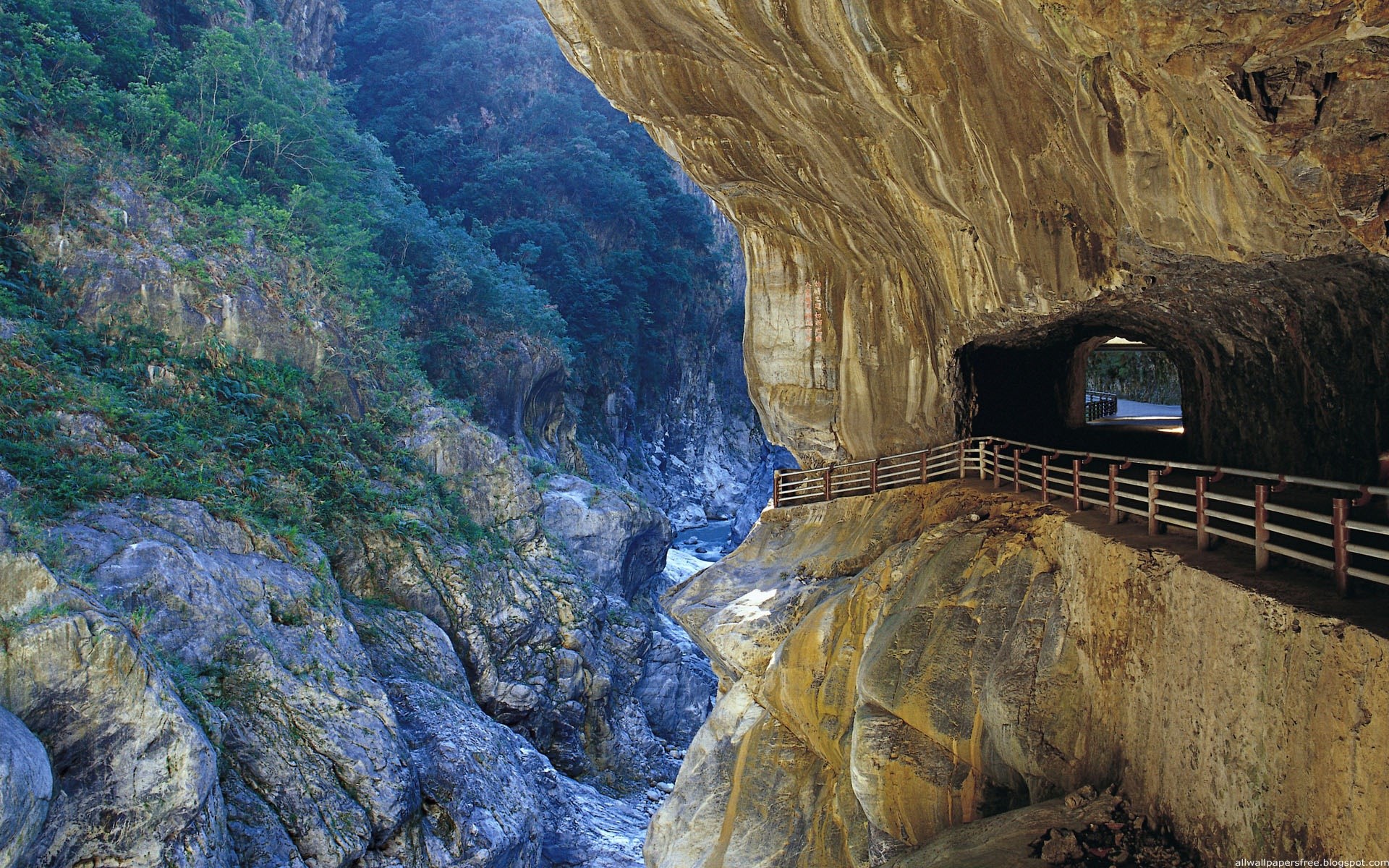 Tunnel carved into a cliff face overlooking a gorge HD Wallpaper