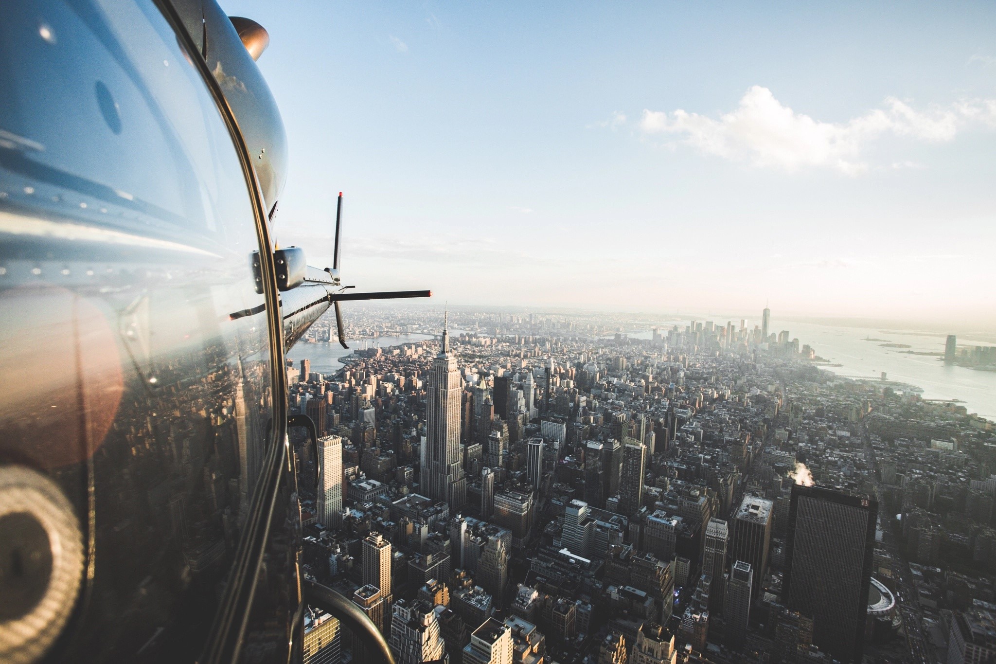 Helicopter flying over New York City skyline HD Wallpaper