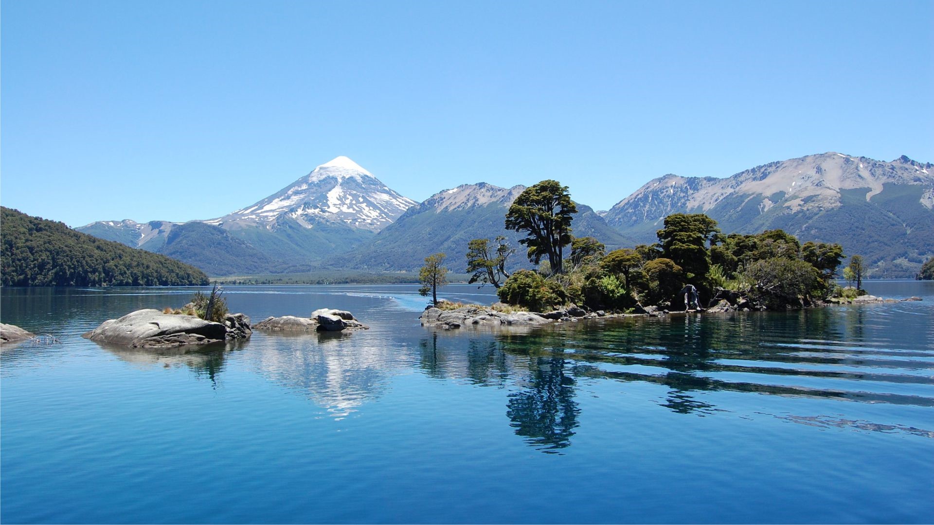 Lake Nahuel Huapi with snow-capped mountains and island HD Wallpaper