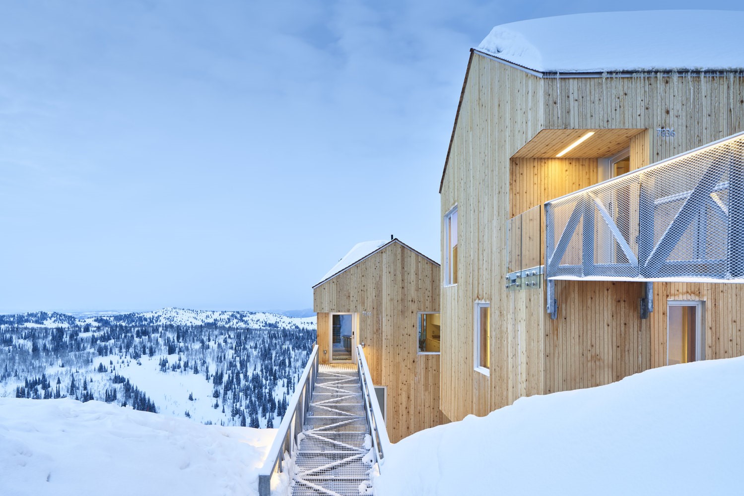 Modern wooden cabins in a snowy mountain landscape HD Wallpaper