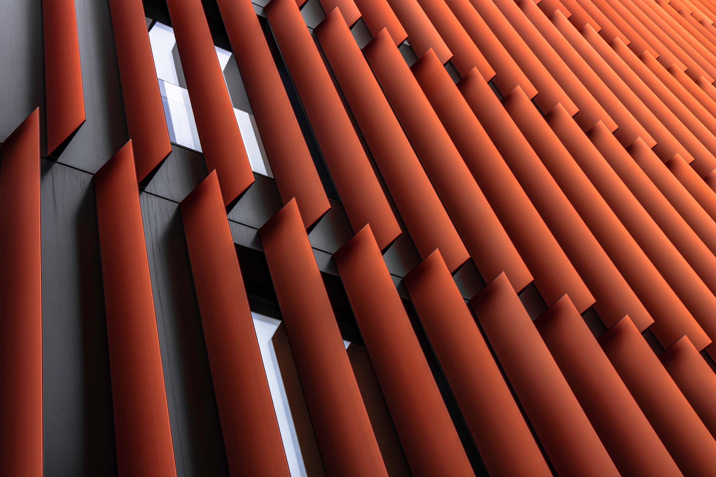 Red fins on a modern building facade HD Wallpaper