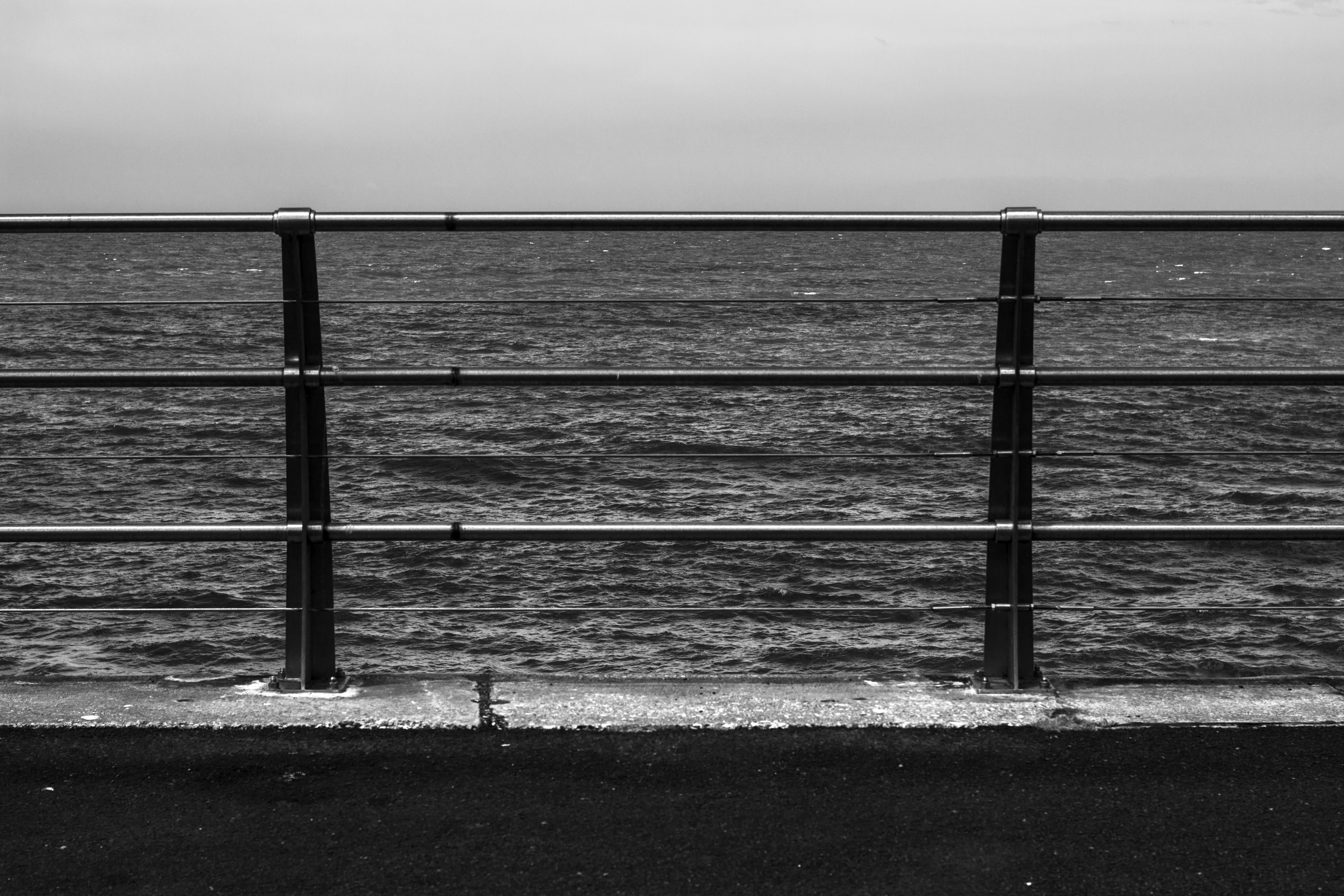 Monochrome photography of a railing by the sea HD Wallpaper