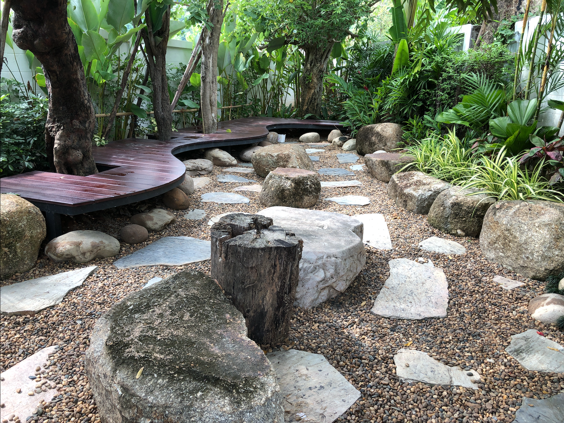 Japanese garden with wooden walkway and rocks HD Wallpaper