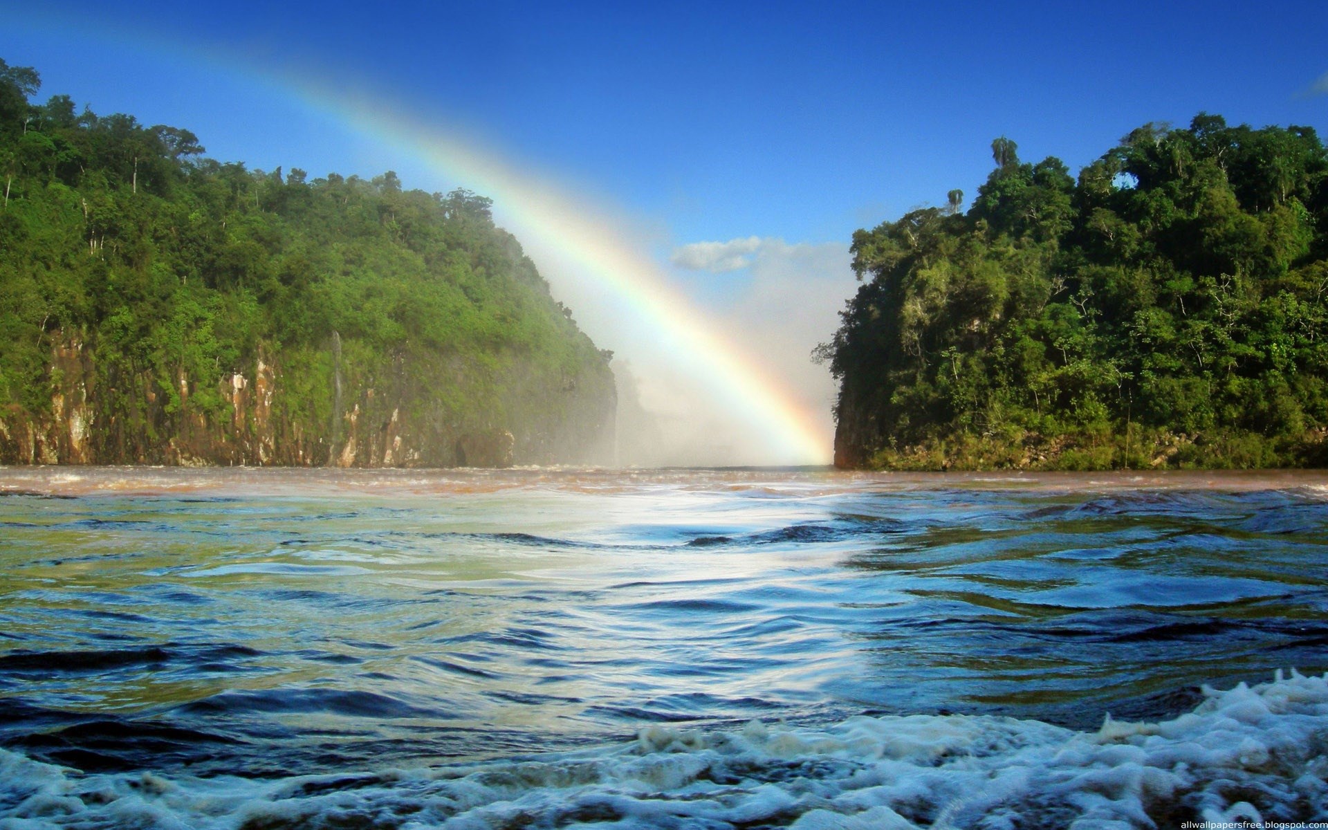 Rainbow over a waterfall between jungle cliffs HD Wallpaper