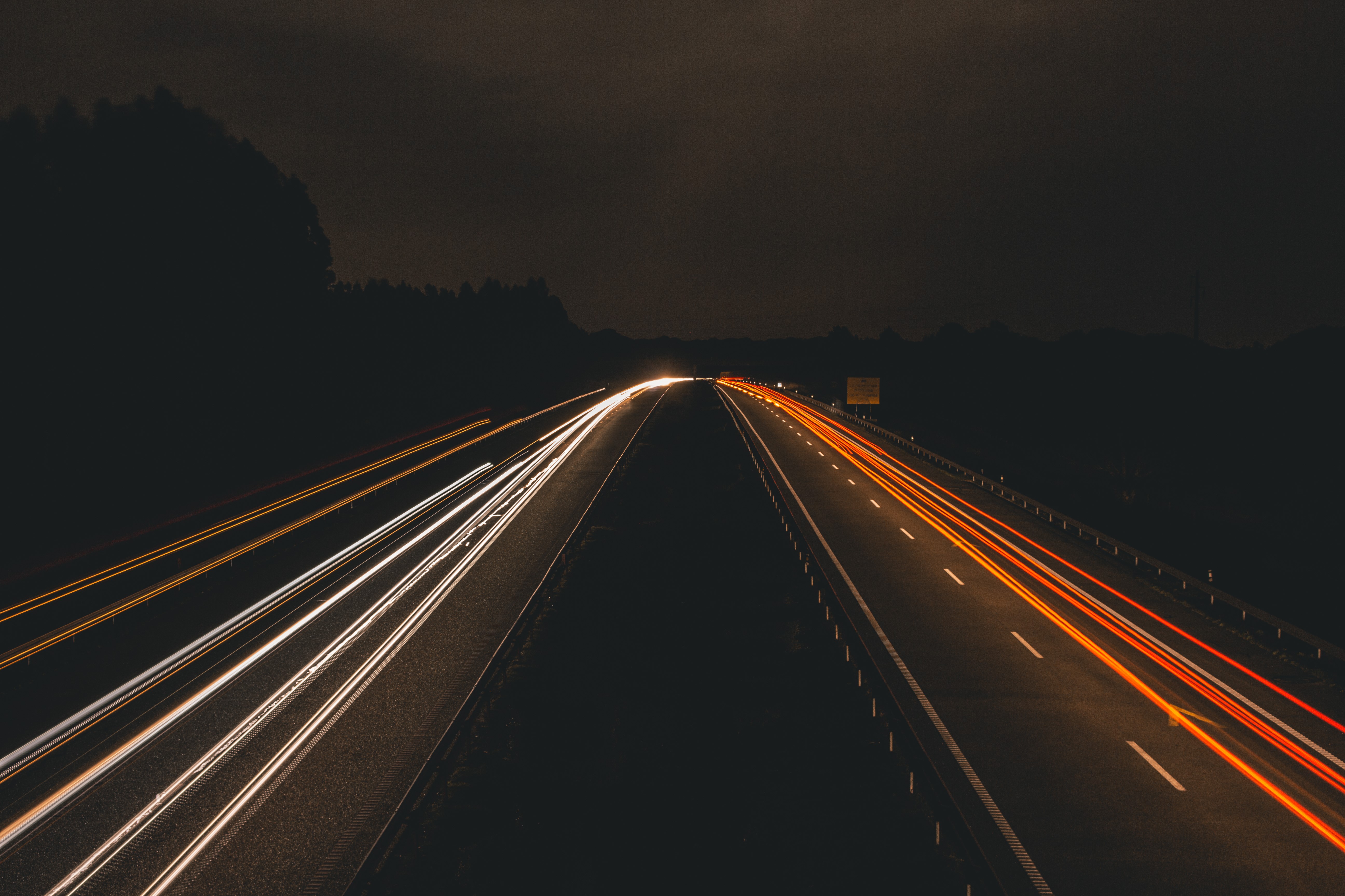 Highway at night with light trails HD Wallpaper