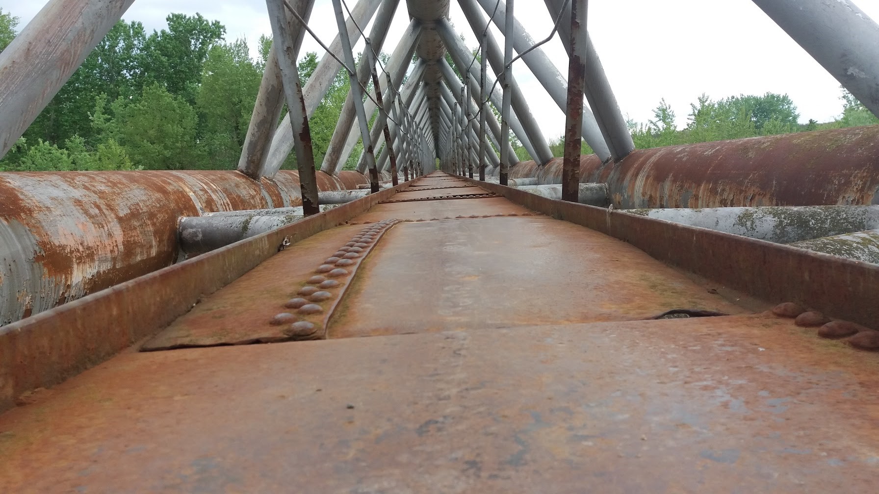 Old rusty metal bridge structure with pipes HD Wallpaper
