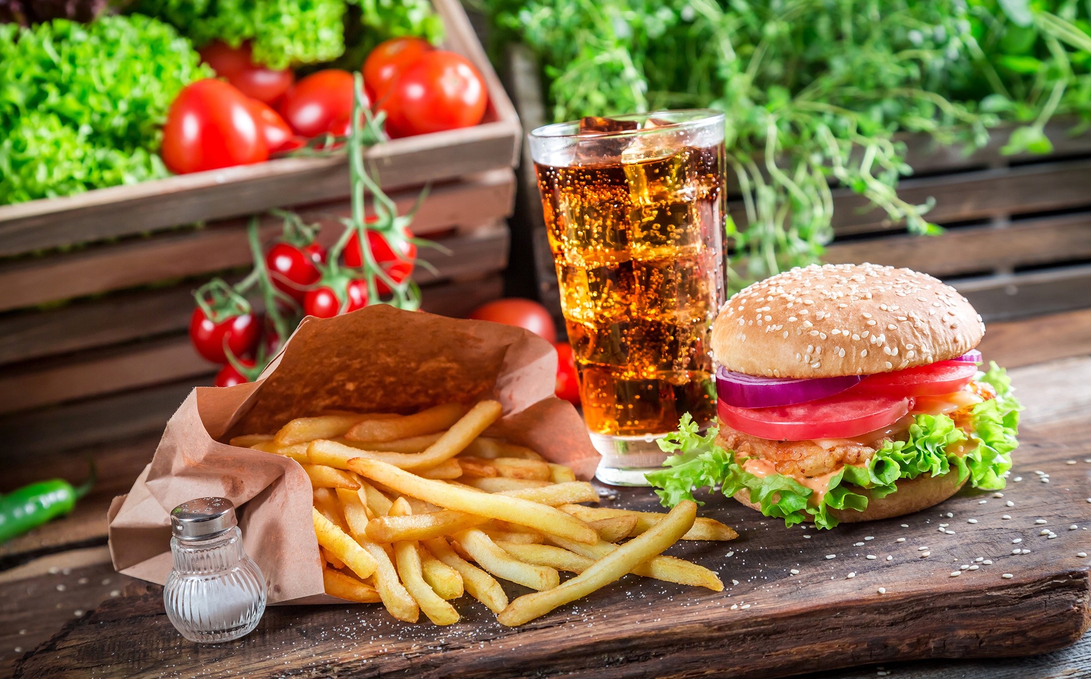 Burger, fries, and soda with fresh vegetables HD Wallpaper