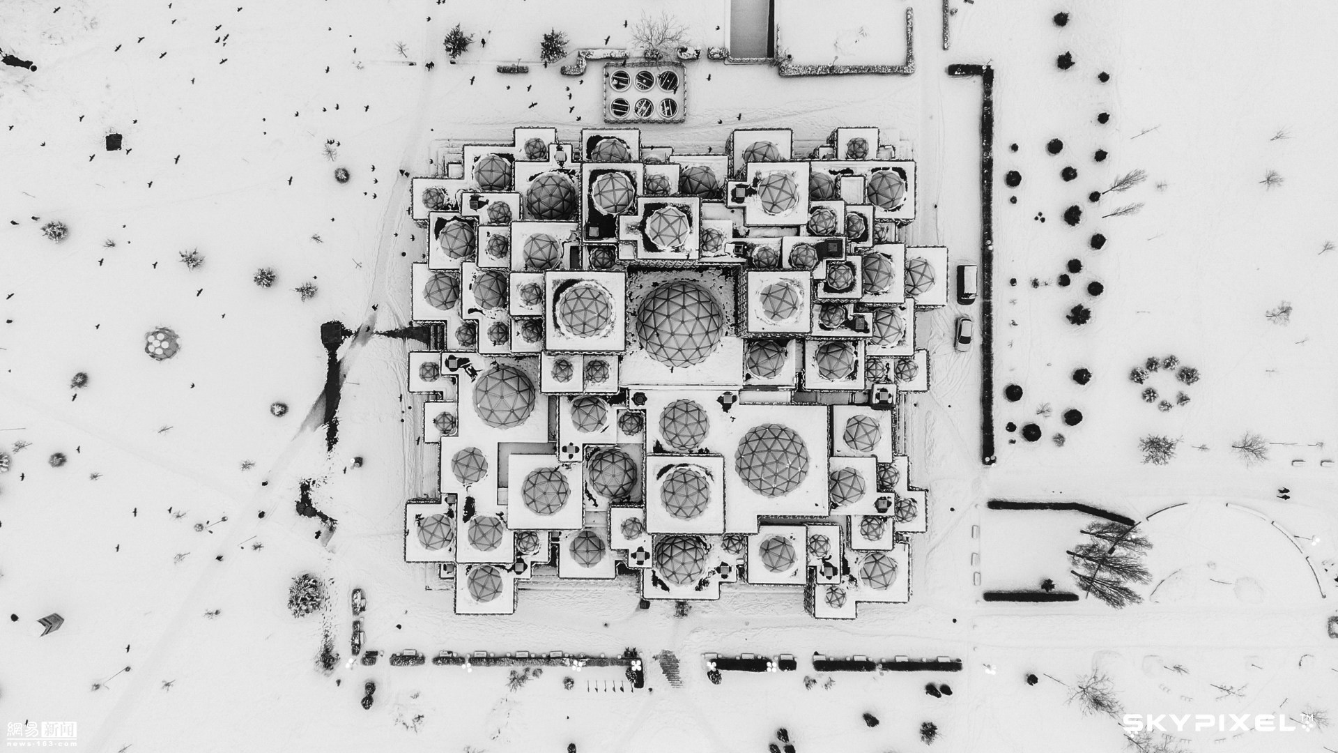 Aerial view of a modern building complex covered in snow HD Wallpaper