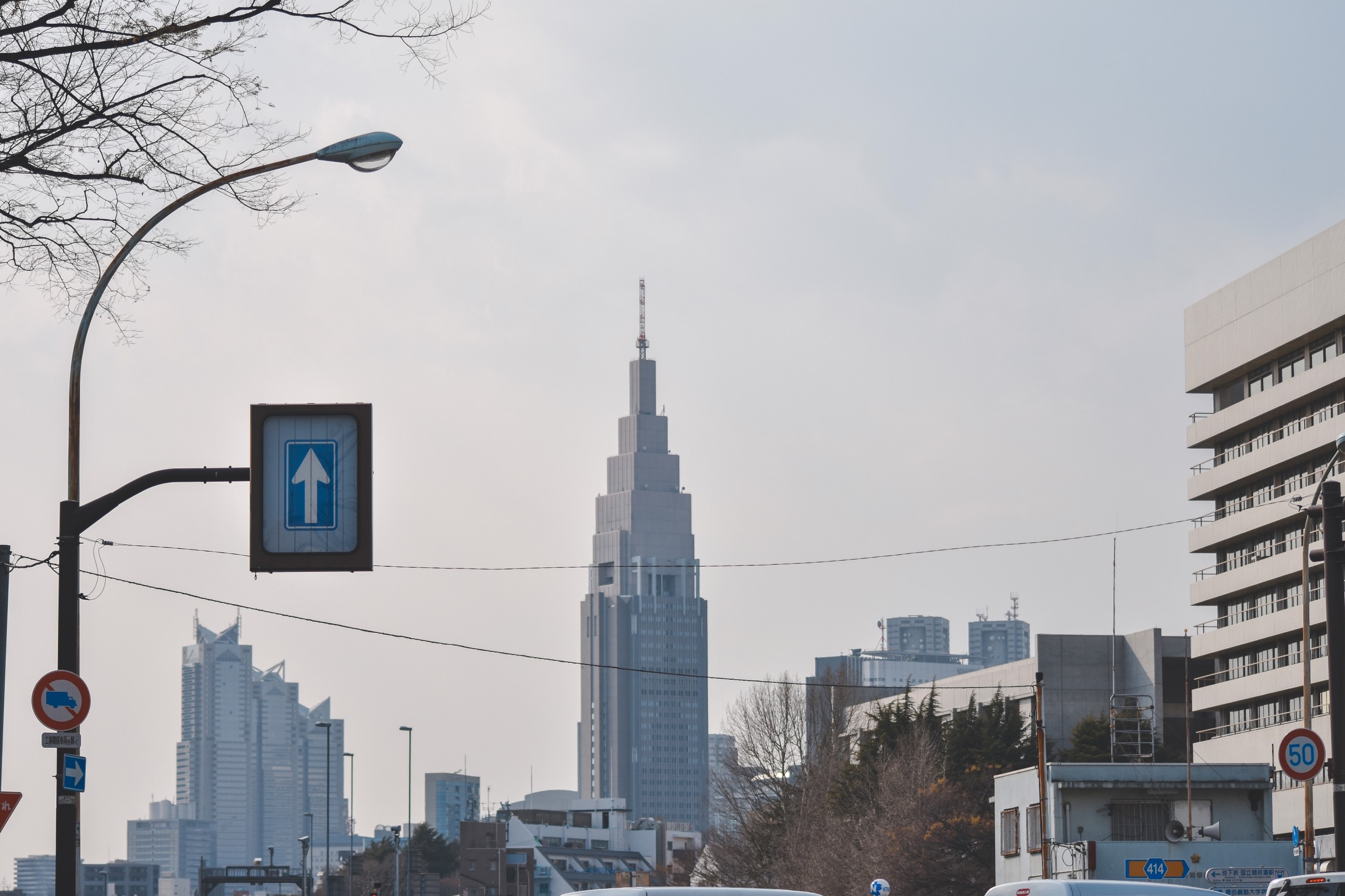 Tokyo cityscape with skyscrapers and street signs HD Wallpaper