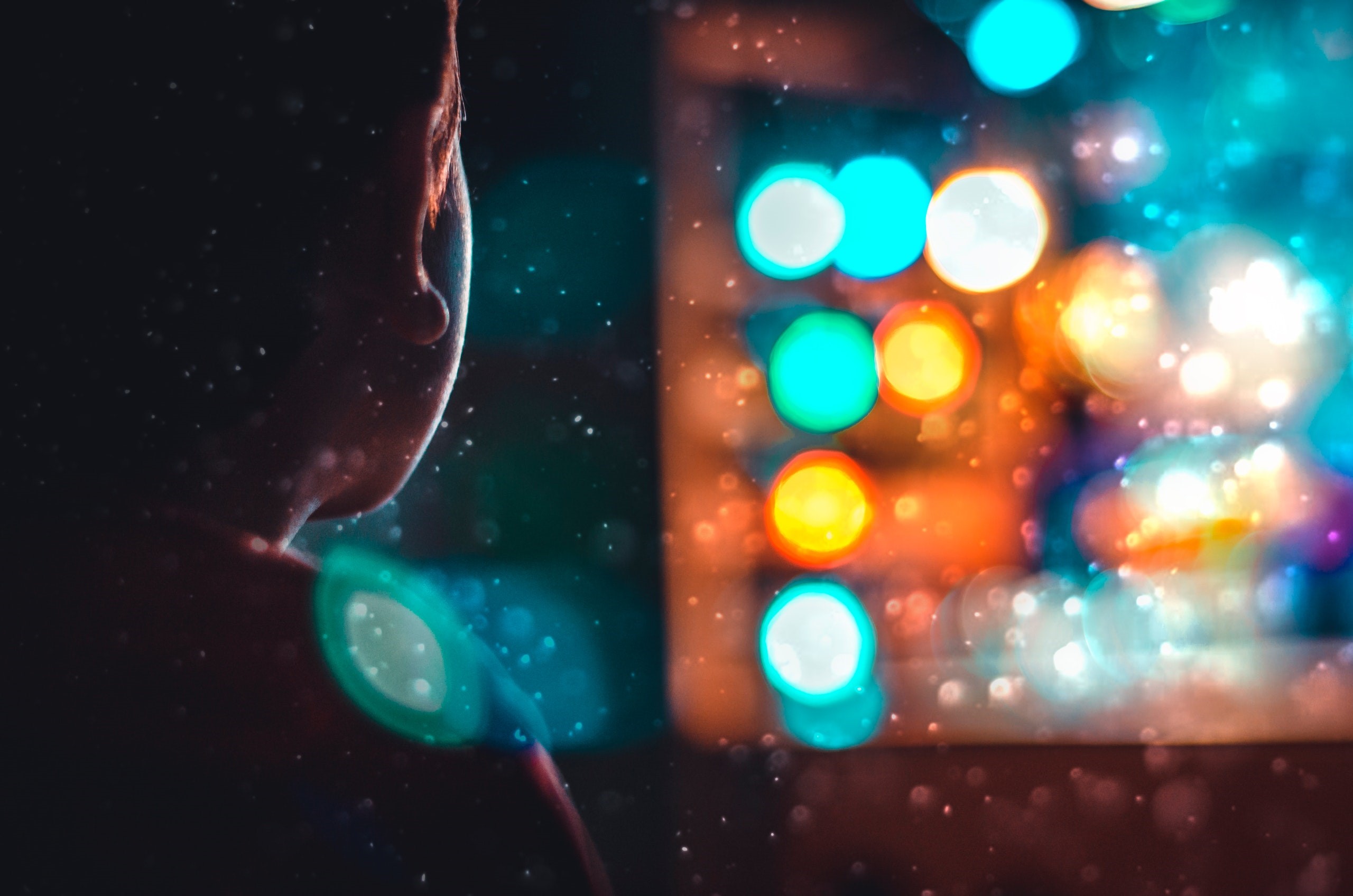 Silhouette of a person looking at bokeh lights HD Wallpaper