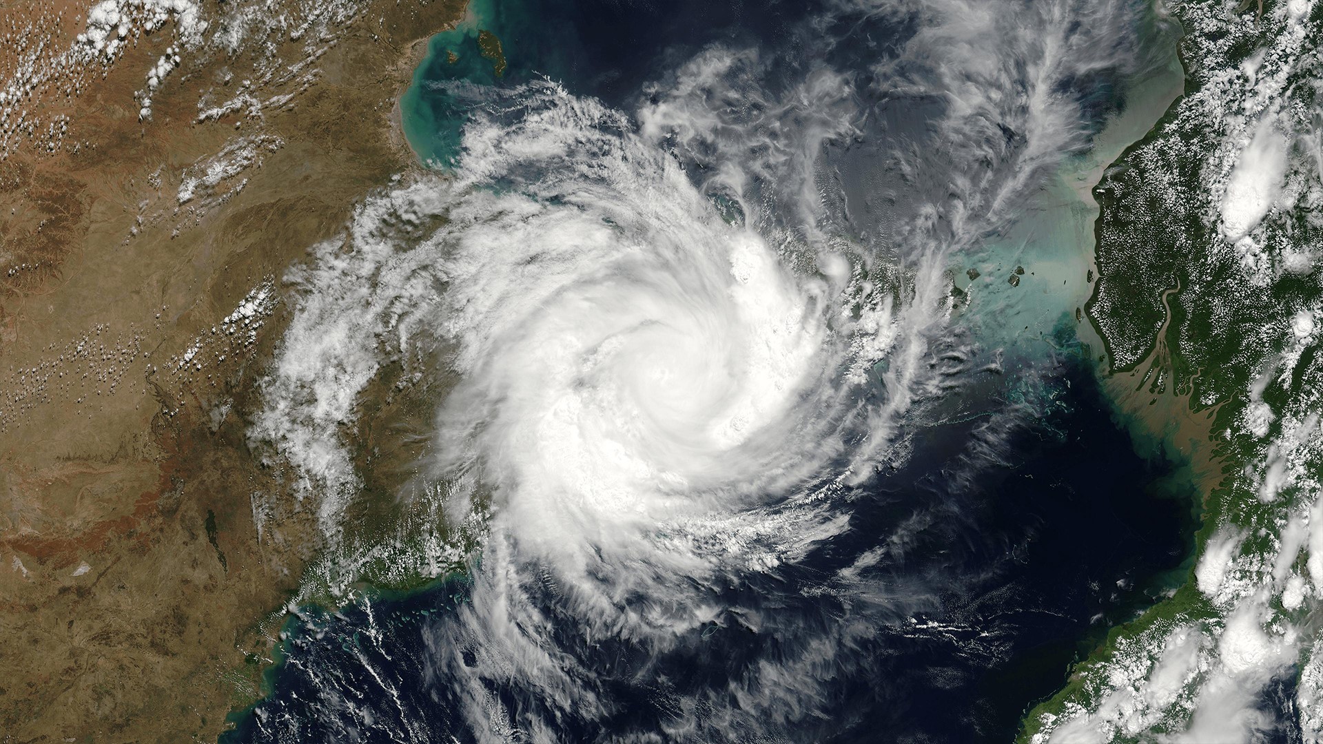 Satellite view of a large hurricane over the ocean and land HD Wallpaper