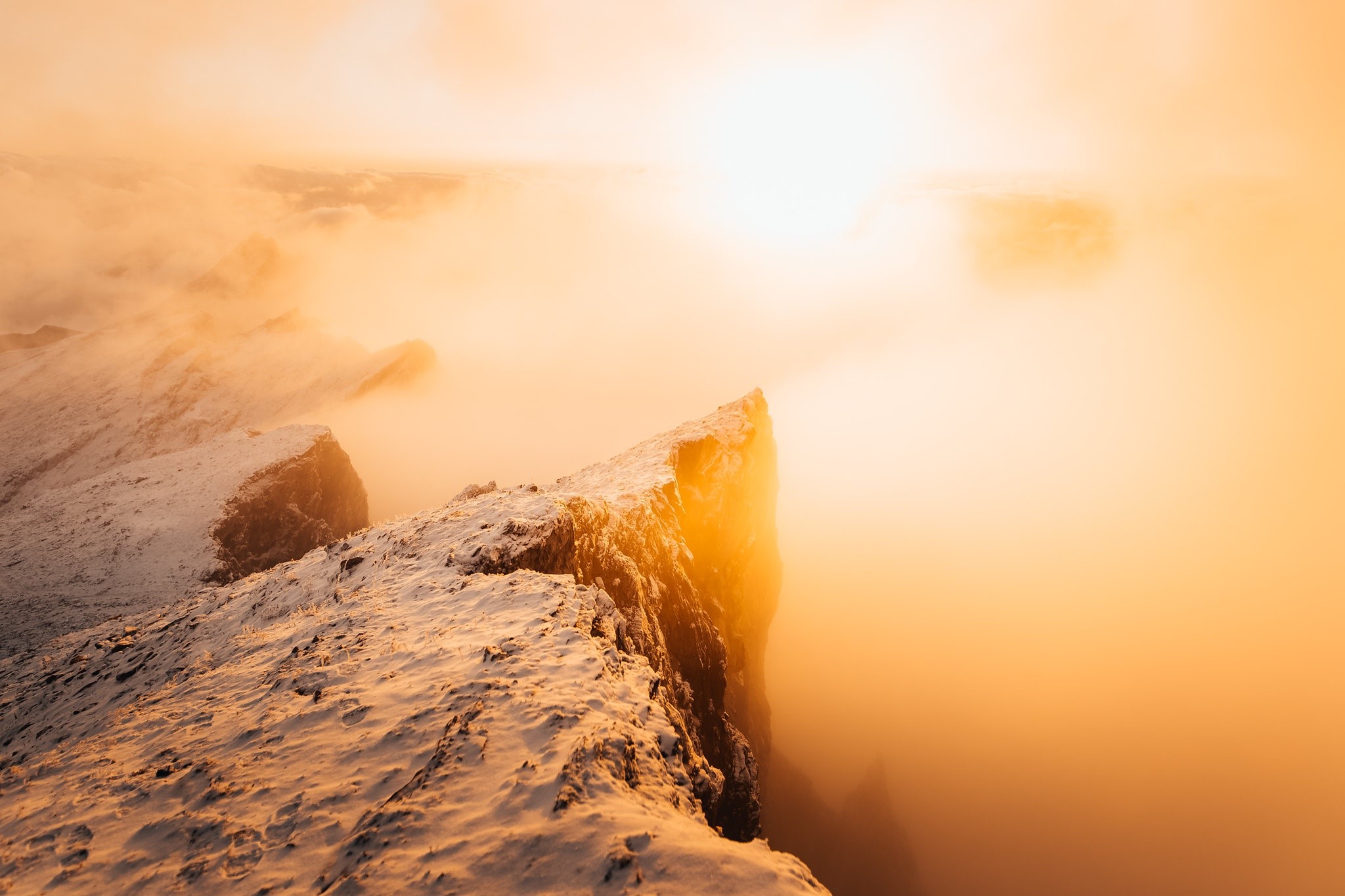 Snowy mountain ridge at sunrise with fog HD Wallpaper