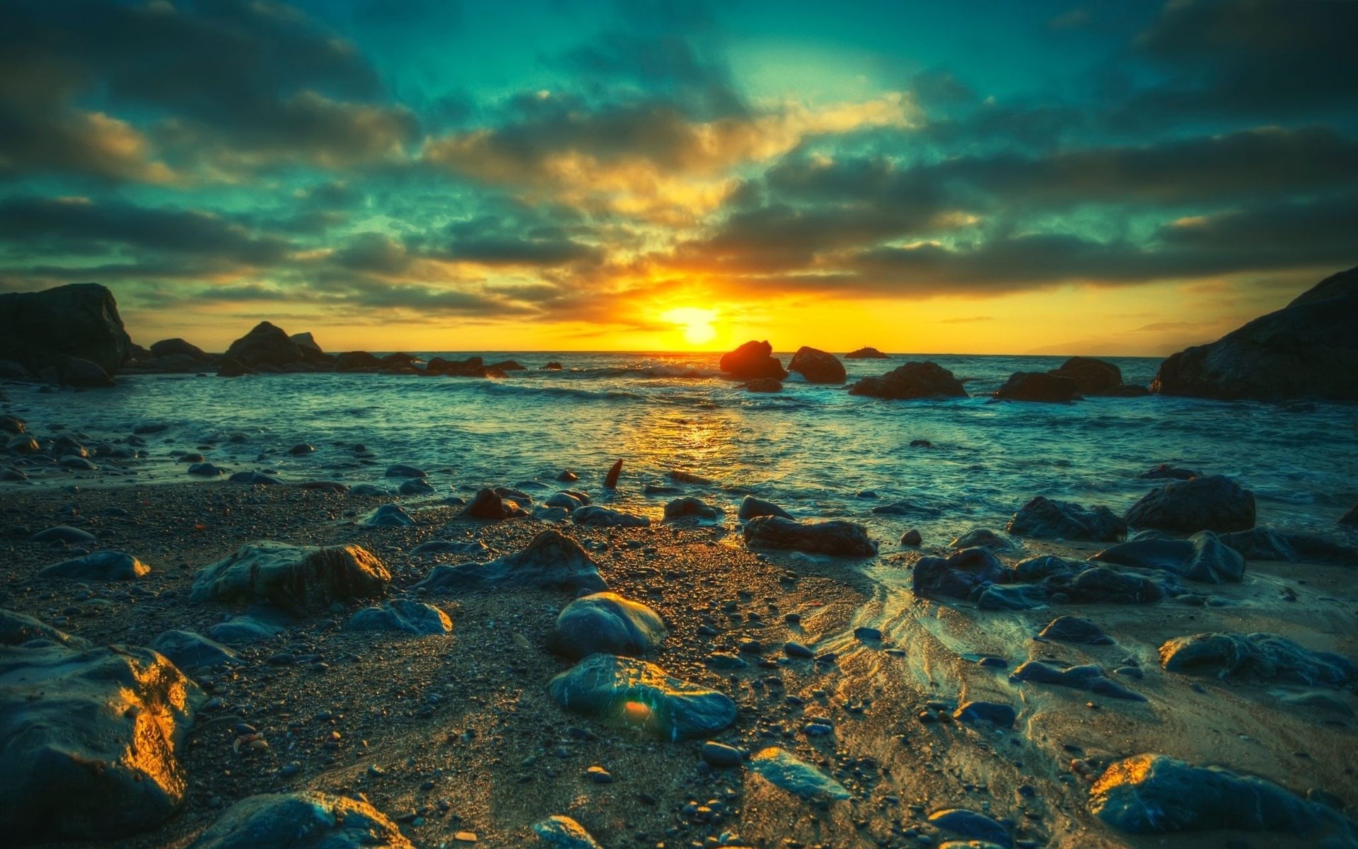 Sunset over a rocky beach with ocean waves HD Wallpaper