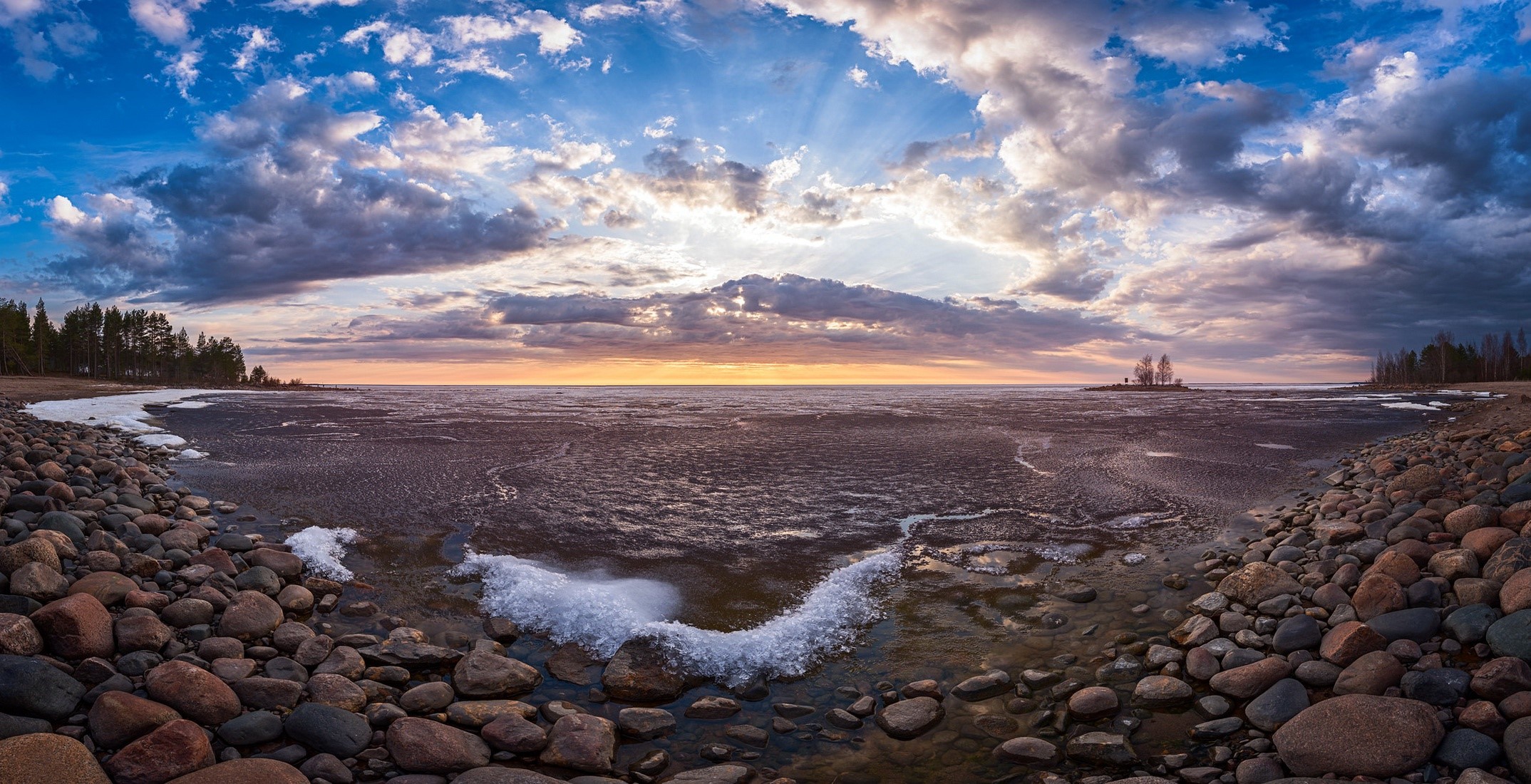 Rocky shore with ice and clouds at sunset HD Wallpaper