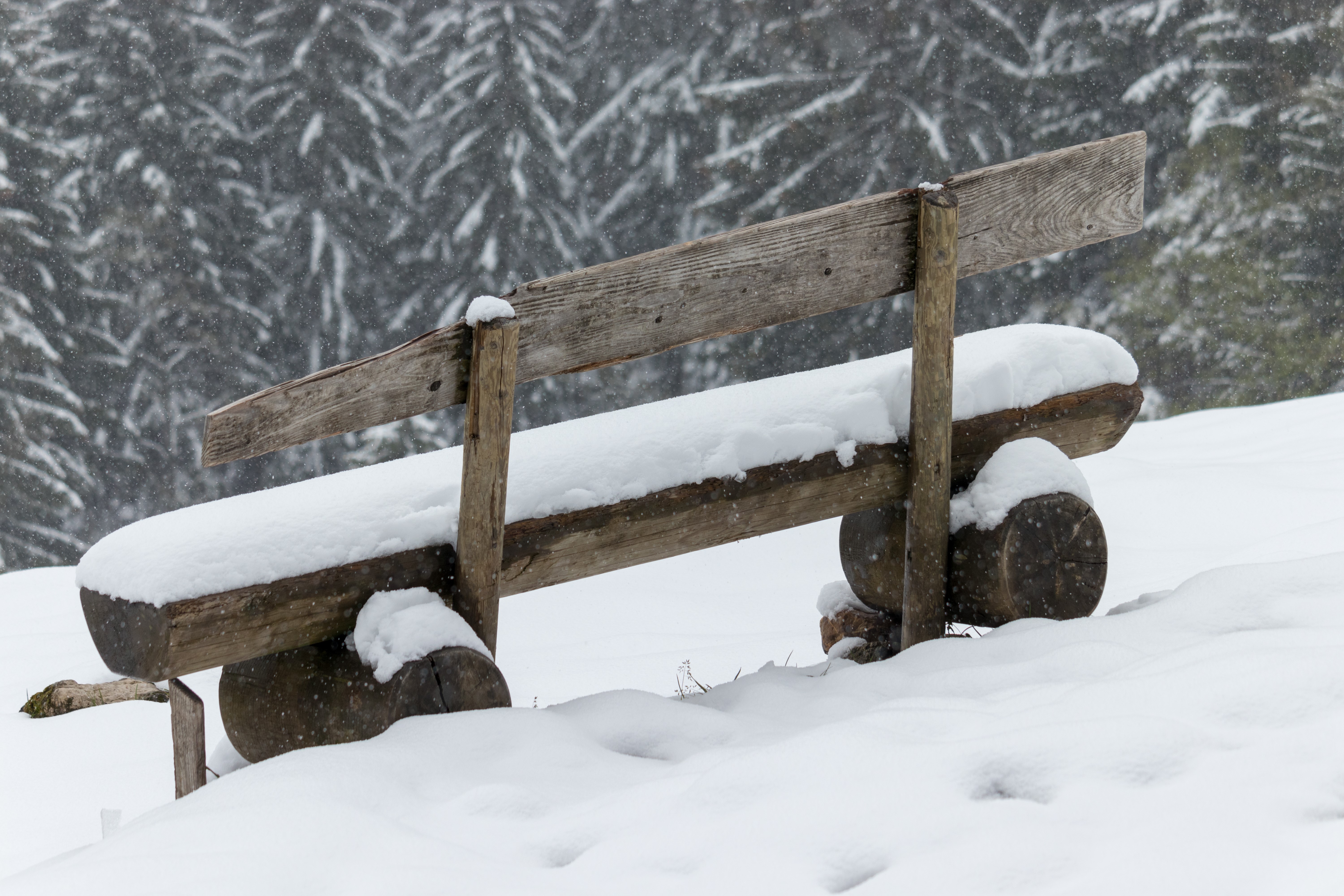 Wooden bench in snow during winter HD Wallpaper