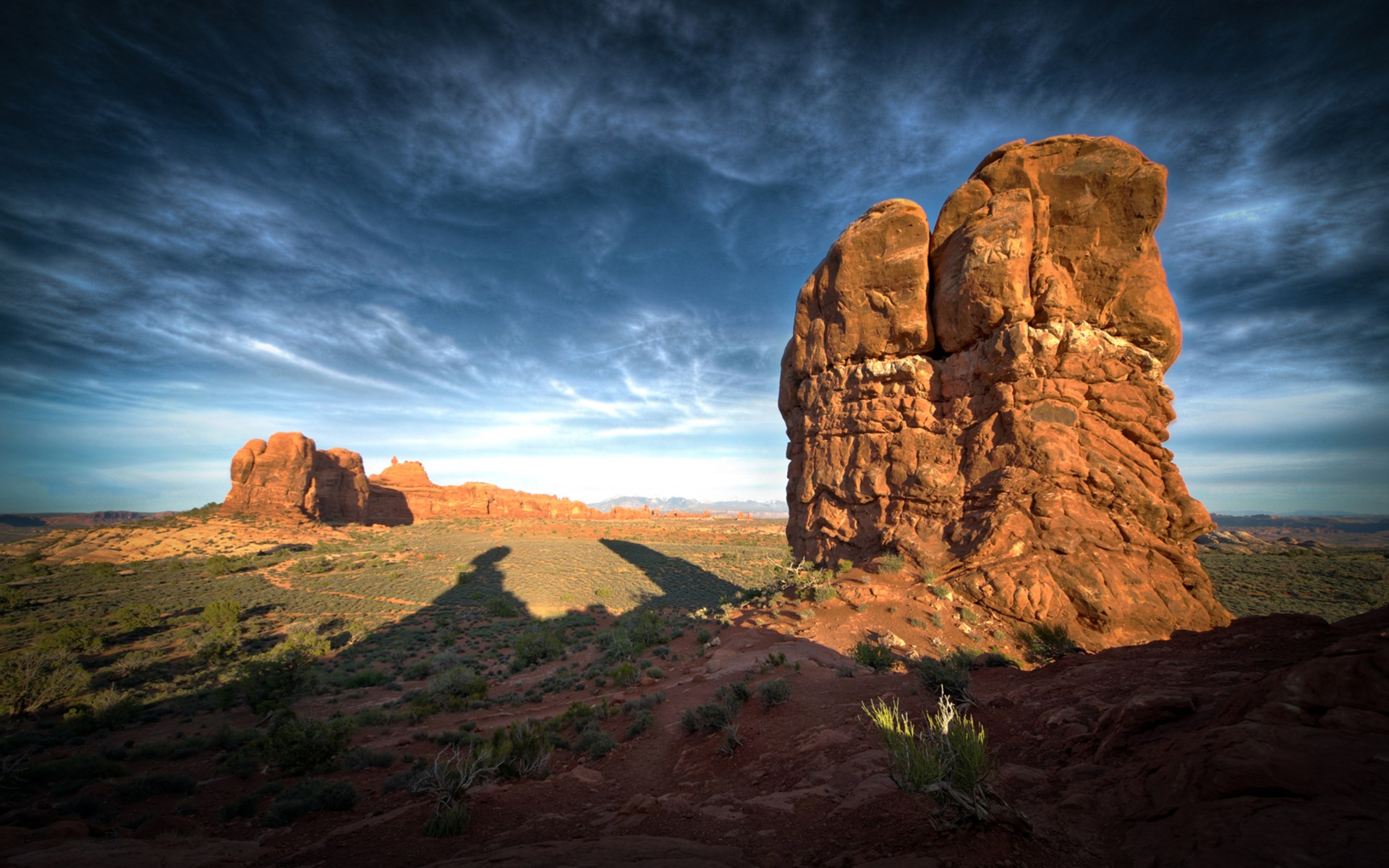 Rock formations in Arches National Park under a cloudy sky HD Wallpaper