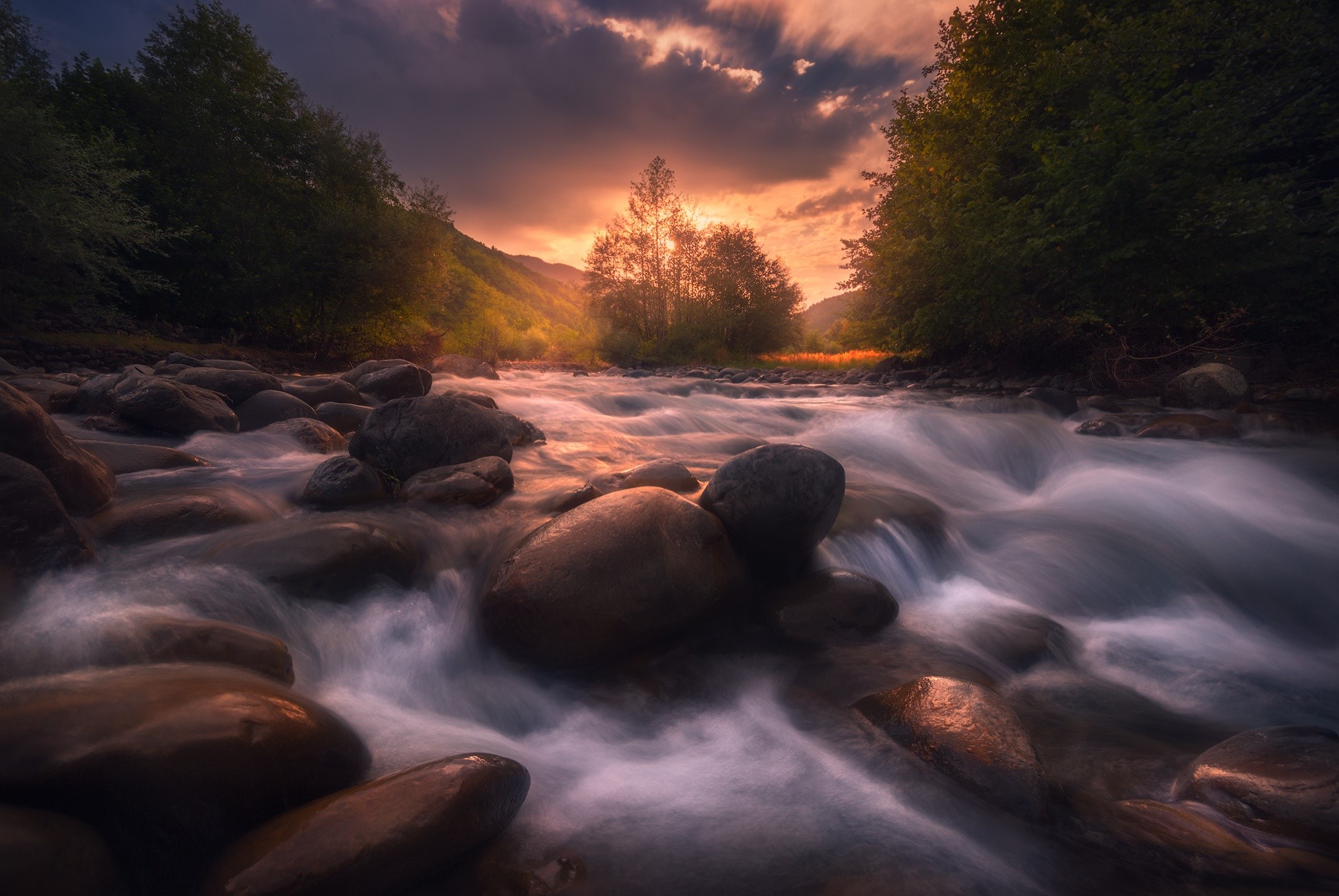 River flowing over stones at sunset HD Wallpaper