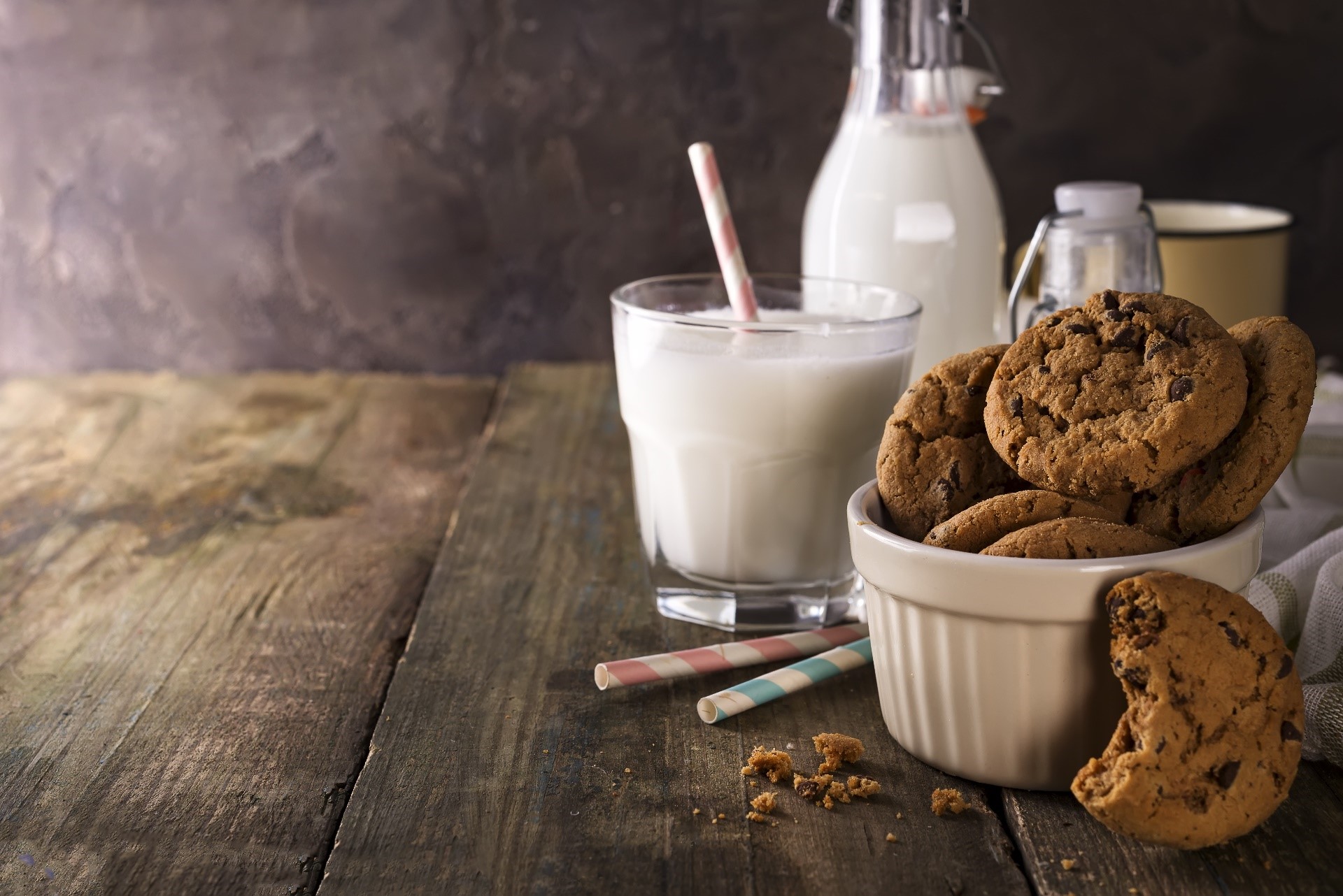 Chocolate chip cookies and milk on a wooden table HD Wallpaper