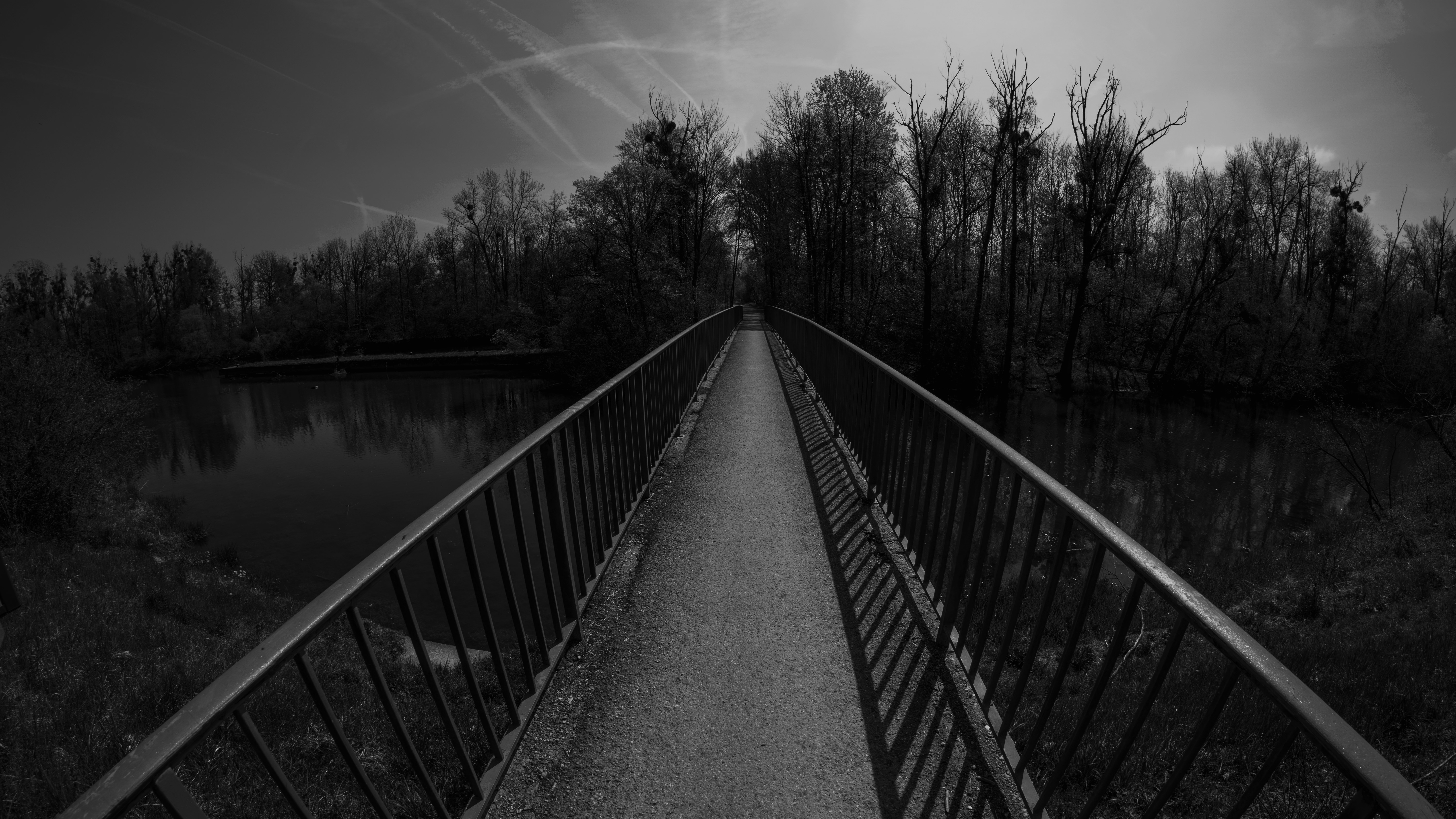 Monochrome bridge over river with trees and sky HD Wallpaper