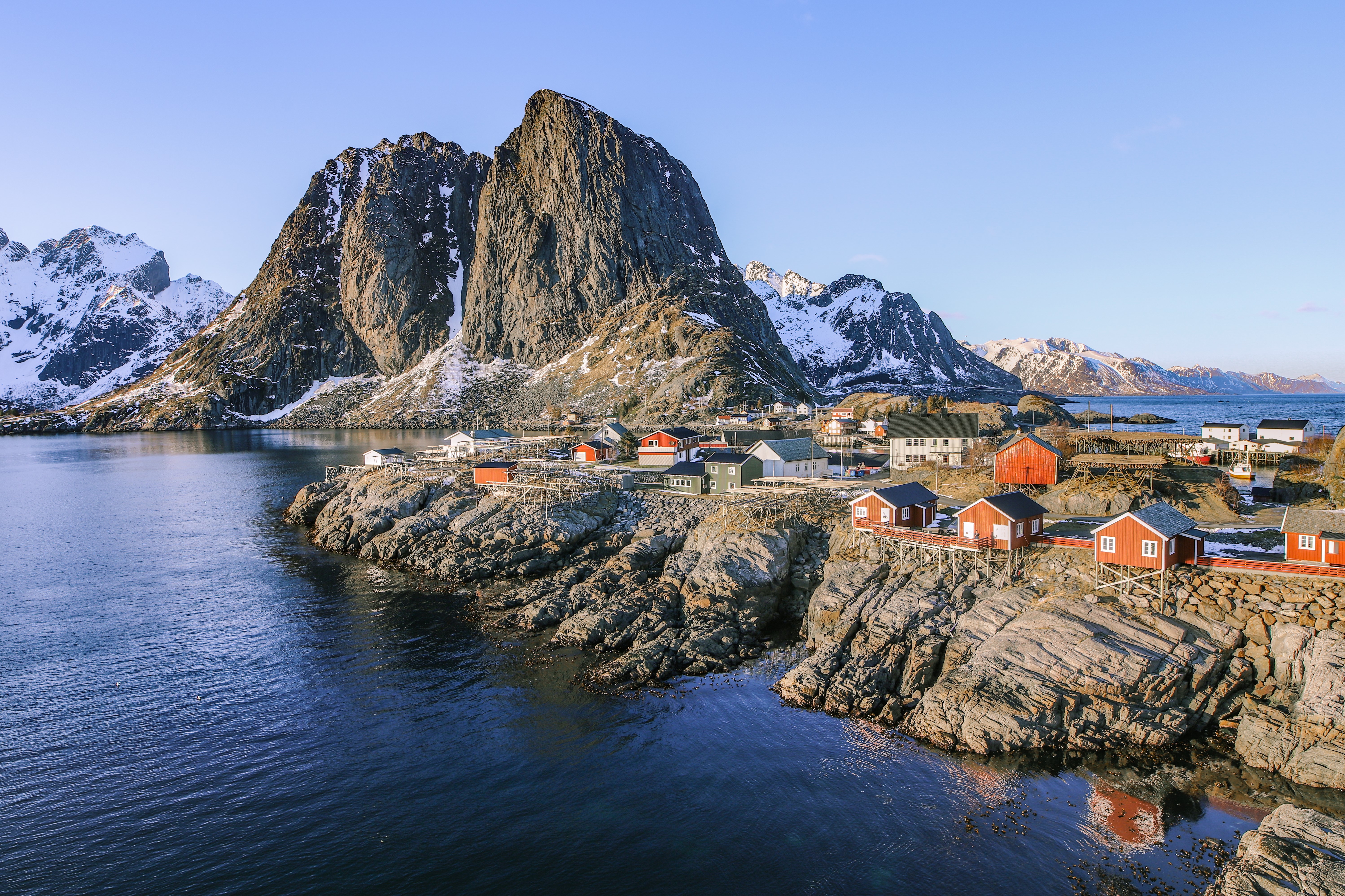 Red cabins on rocky shore with mountains in Lofoten, Norway HD Wallpaper
