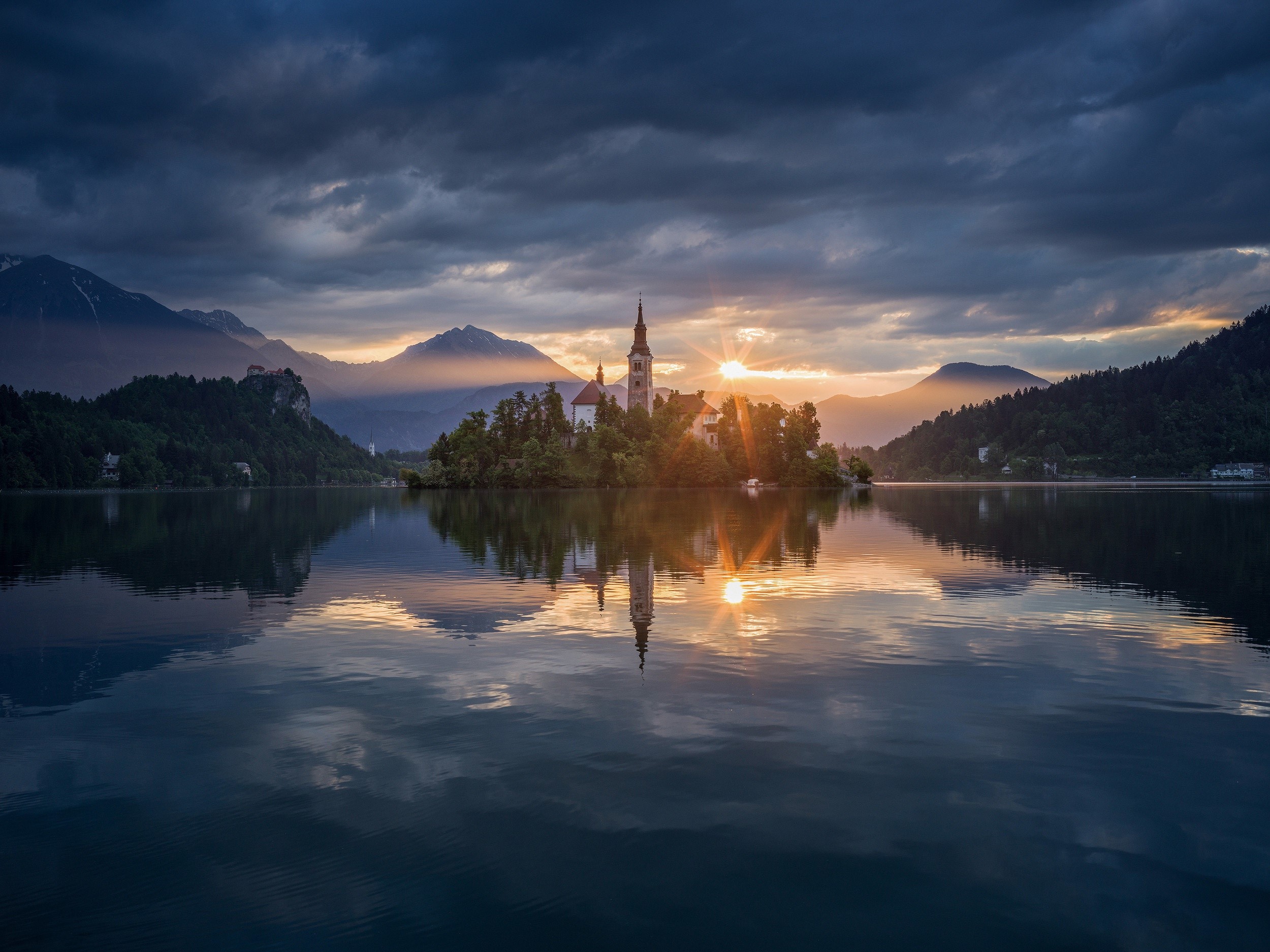 Church on island in lake with mountains and sunset HD Wallpaper
