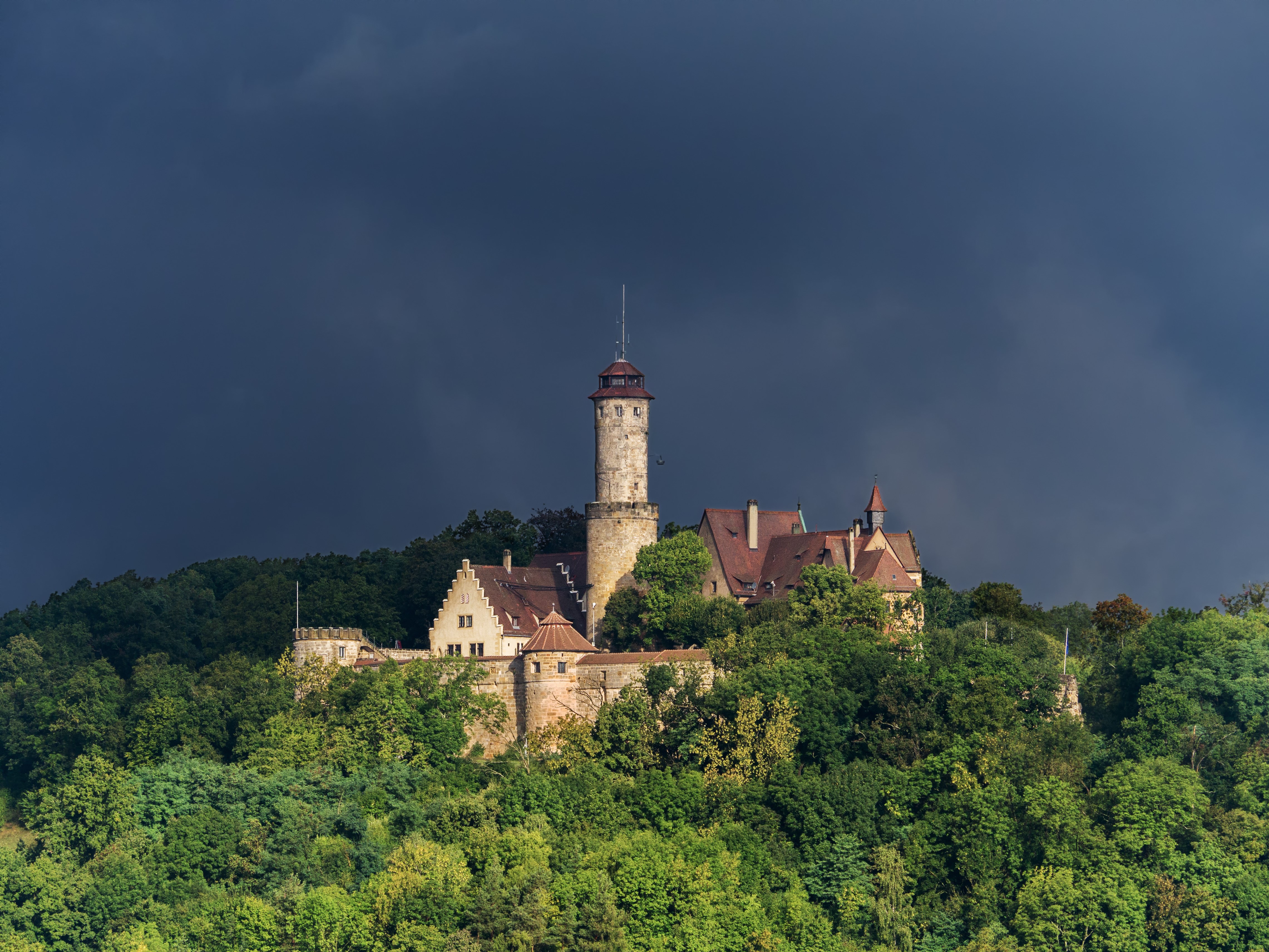 Castle on a hill under dark sky HD Wallpaper