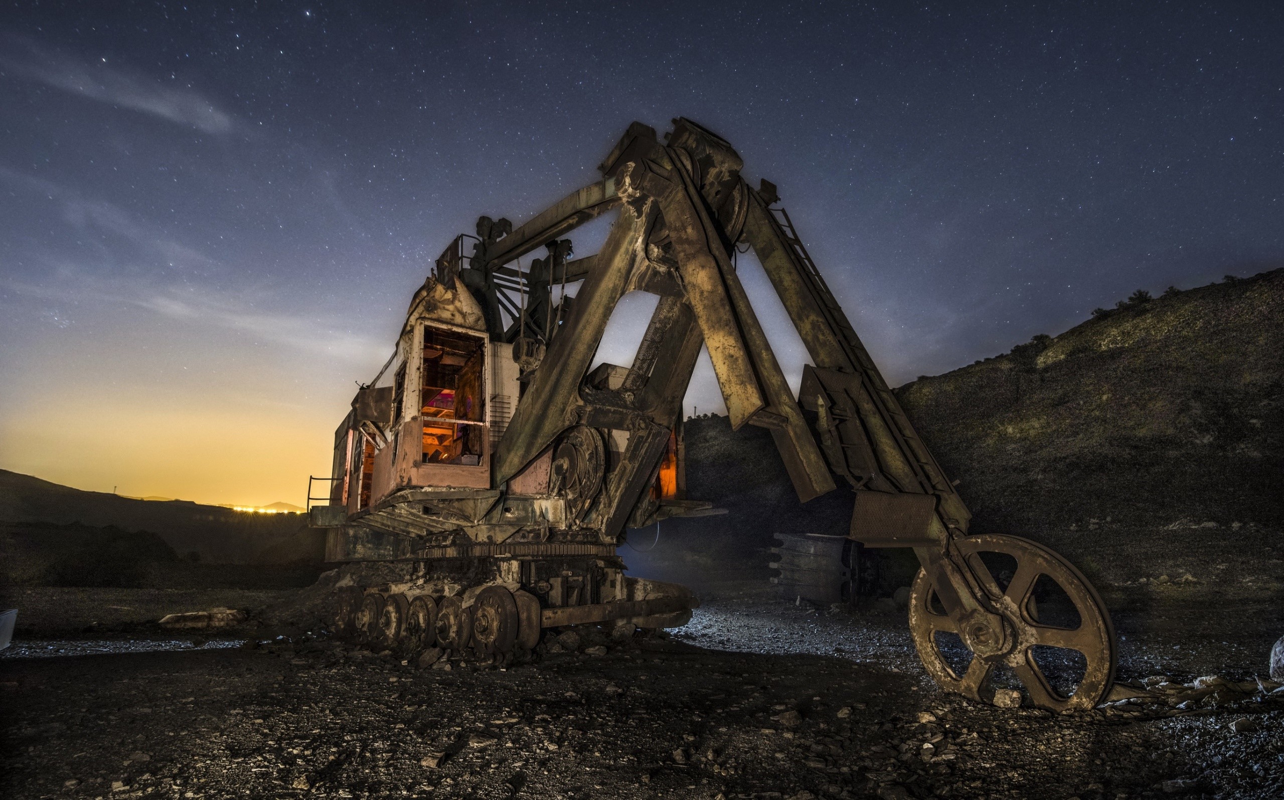 Abandoned excavator at night under starry sky HD Wallpaper