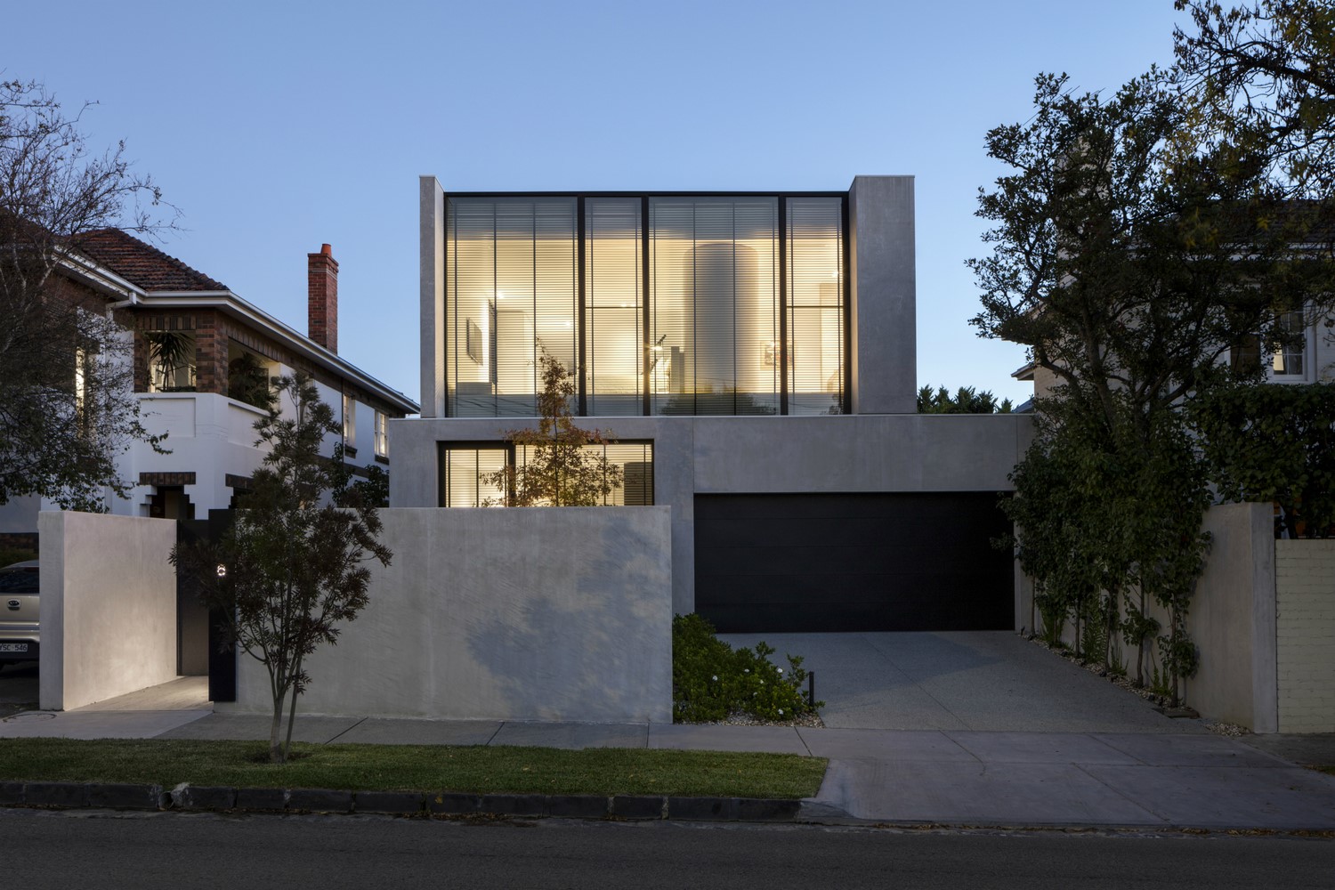 Modern concrete house with glass facade and garage HD Wallpaper