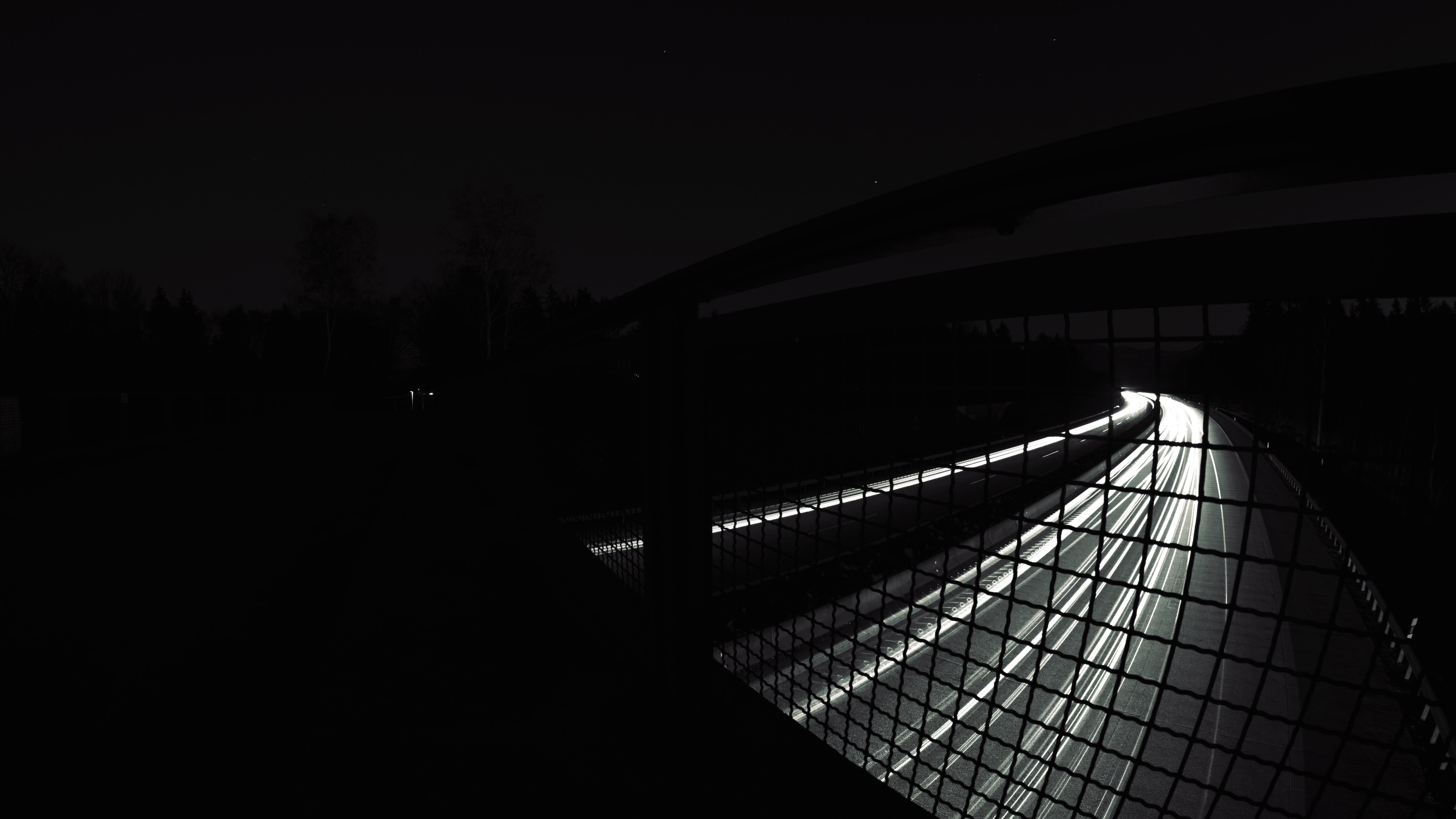 4K monochrome long exposure of a highway at night HD Wallpaper