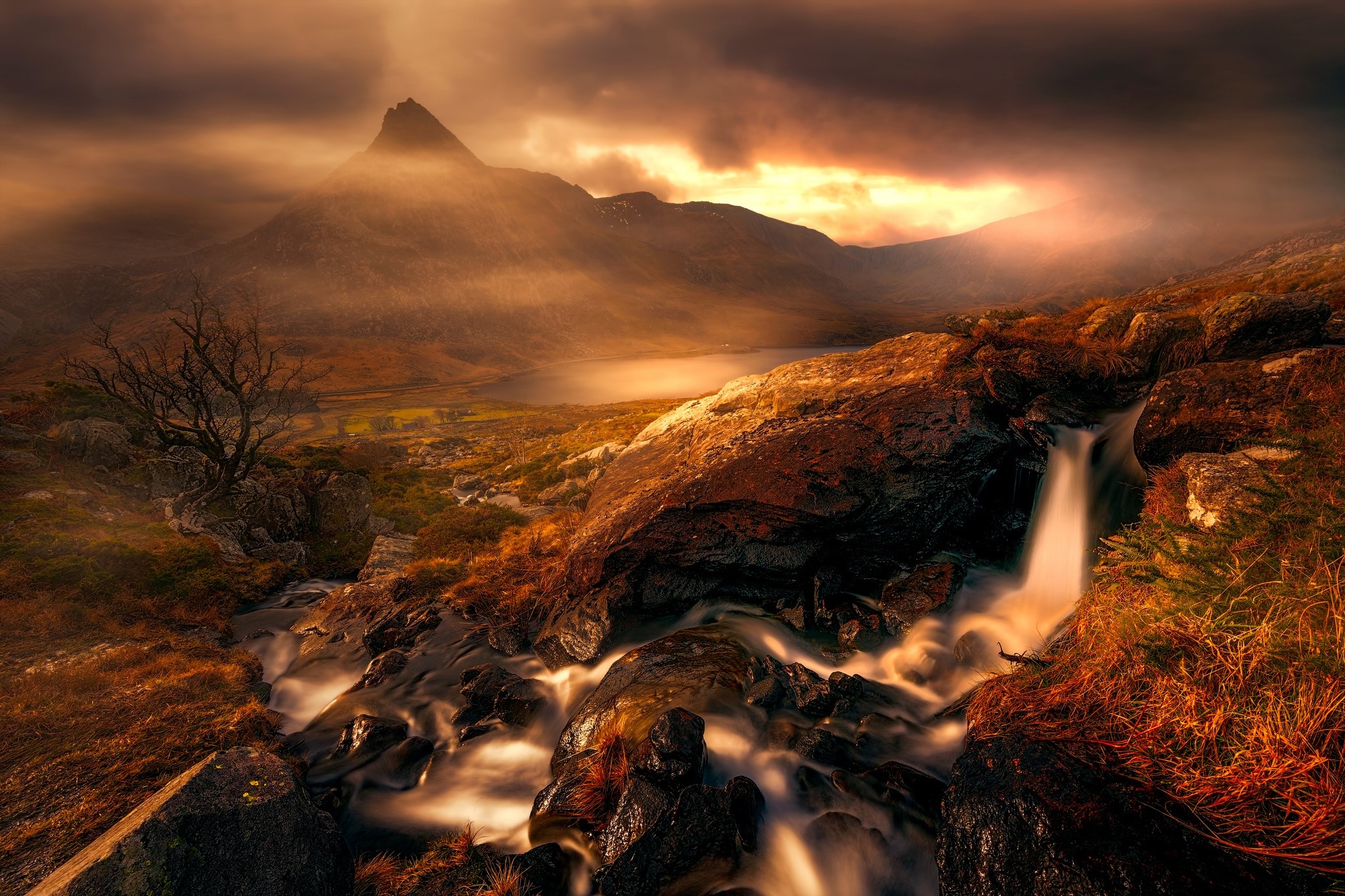 Mountain landscape with a waterfall and dramatic sky HD Wallpaper