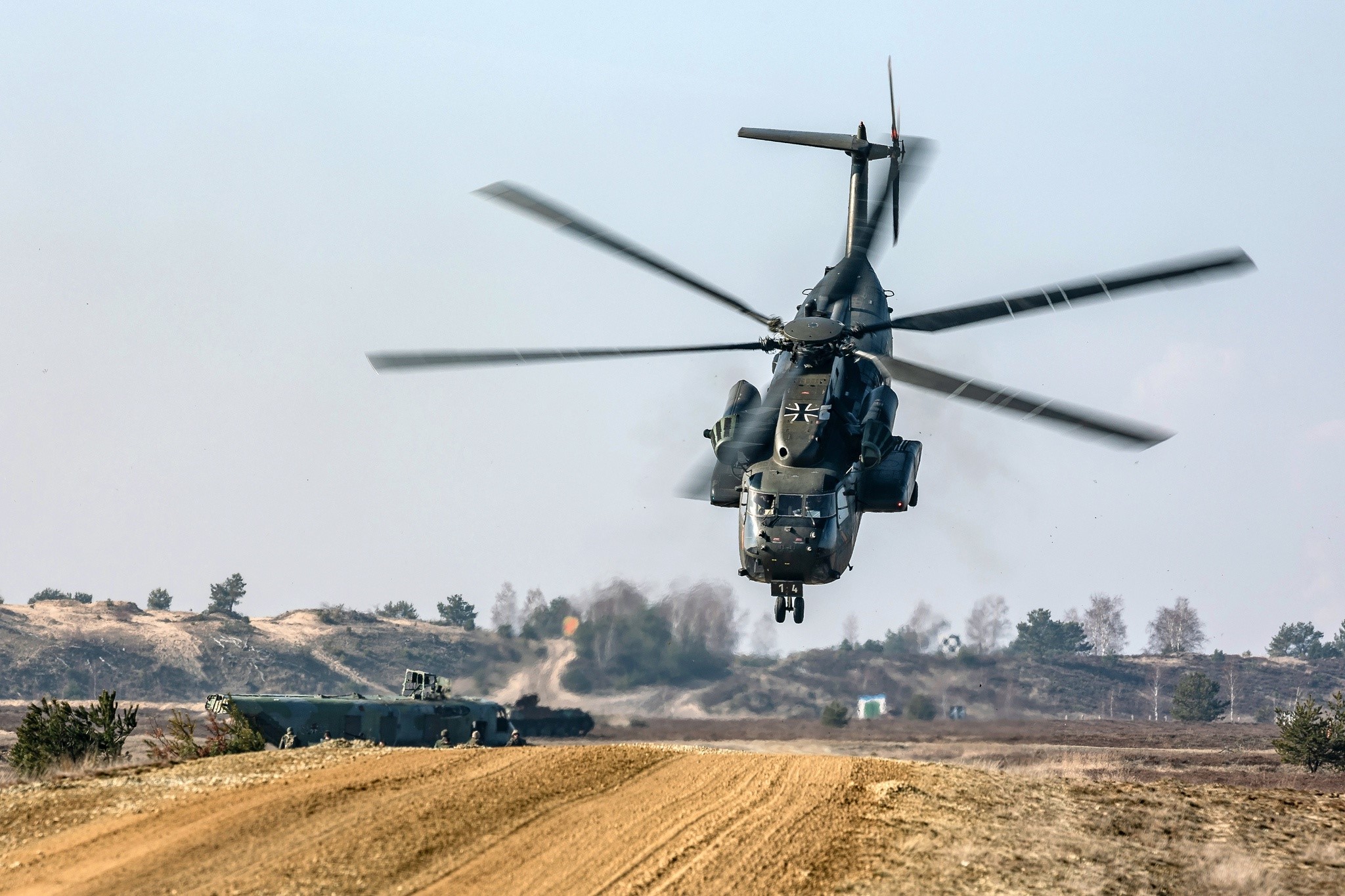 German Army helicopter in flight over a training ground HD Wallpaper