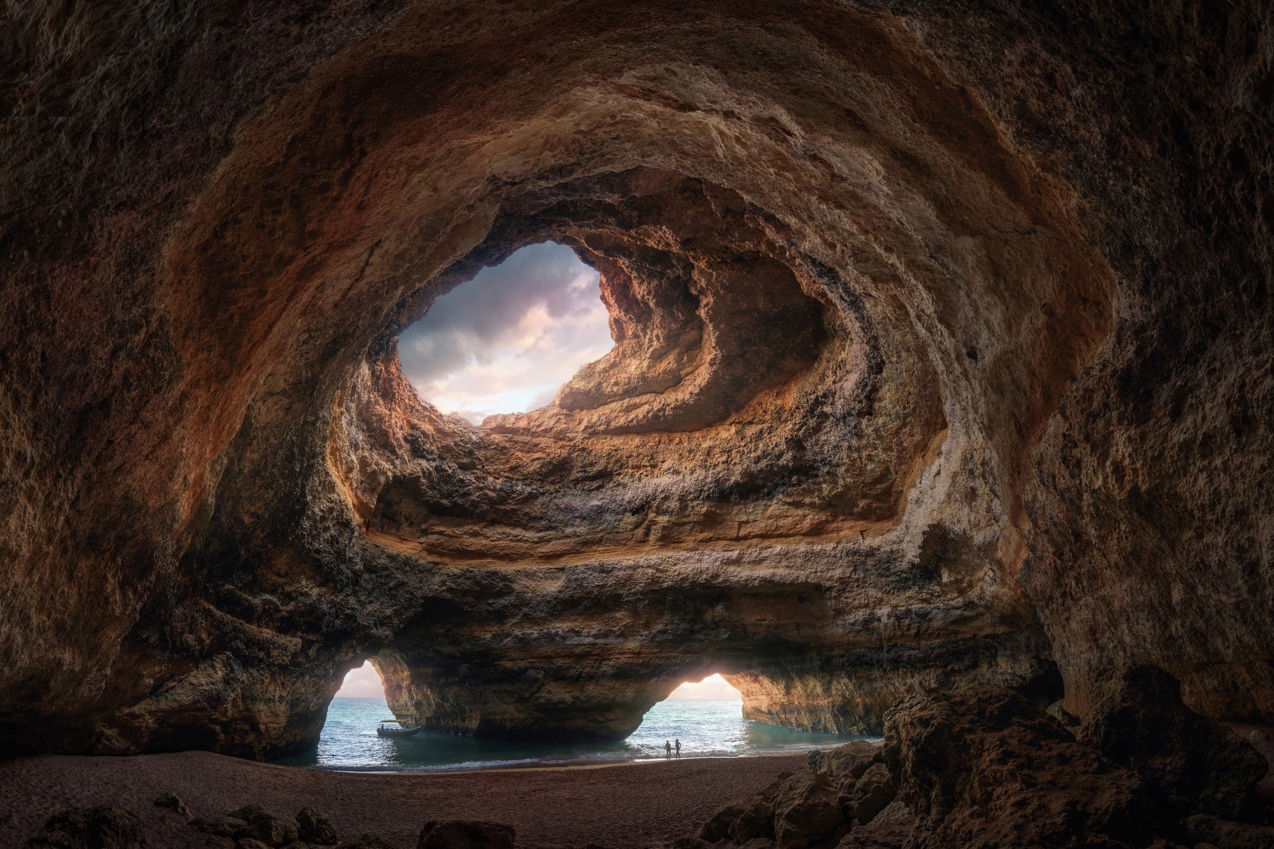 Cave opening with view of the ocean and sky HD Wallpaper