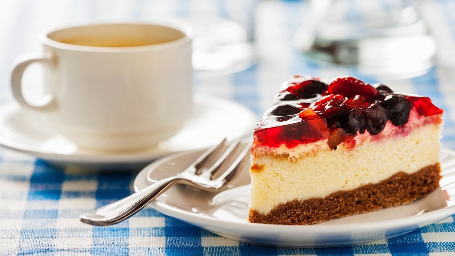 Slice of fruit jelly cheesecake with coffee and fork HD Wallpaper