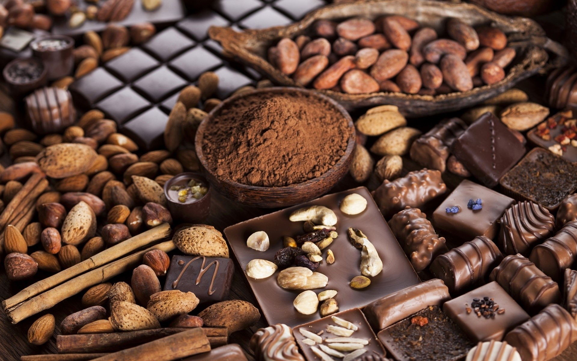 Assortment of chocolates, nuts, and cocoa powder HD Wallpaper