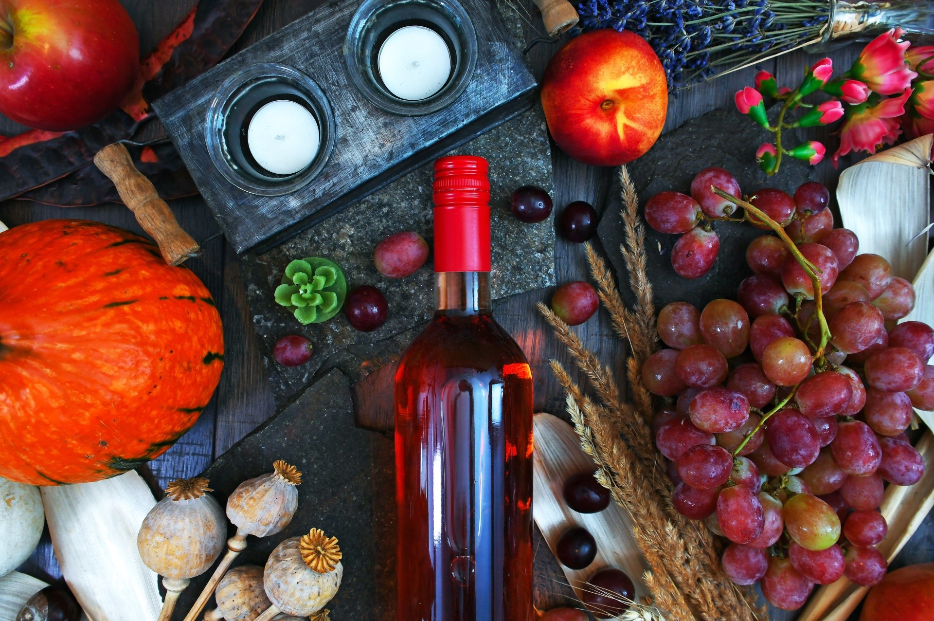 Bottle of rose wine with grapes, pumpkin, and apples HD Wallpaper