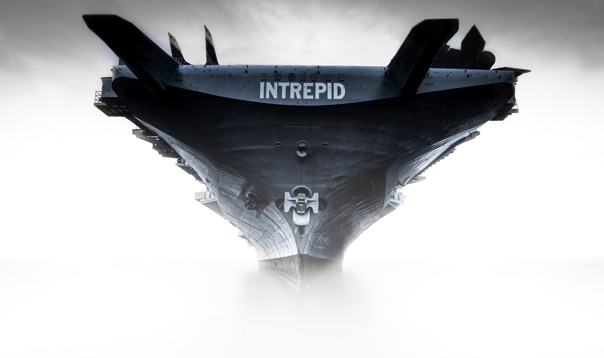 USS Intrepid aircraft carrier emerging from fog HD Wallpaper