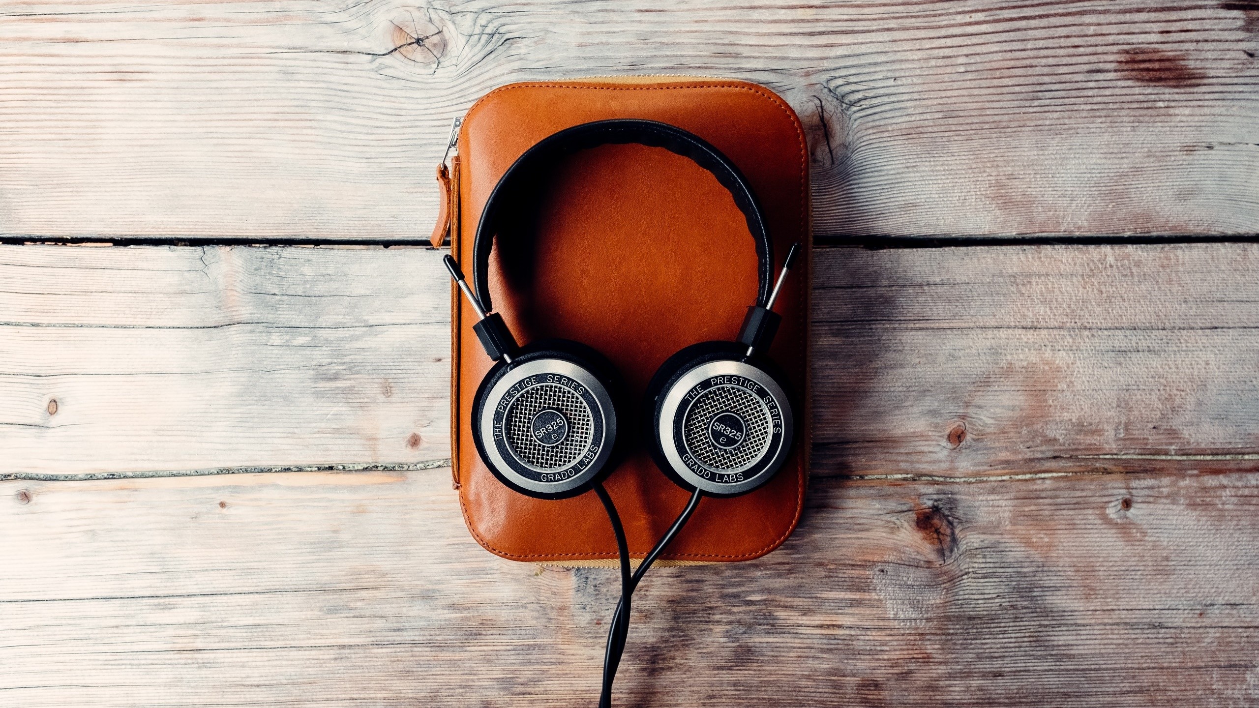 Grado GR325 headphones on a leather case HD Wallpaper