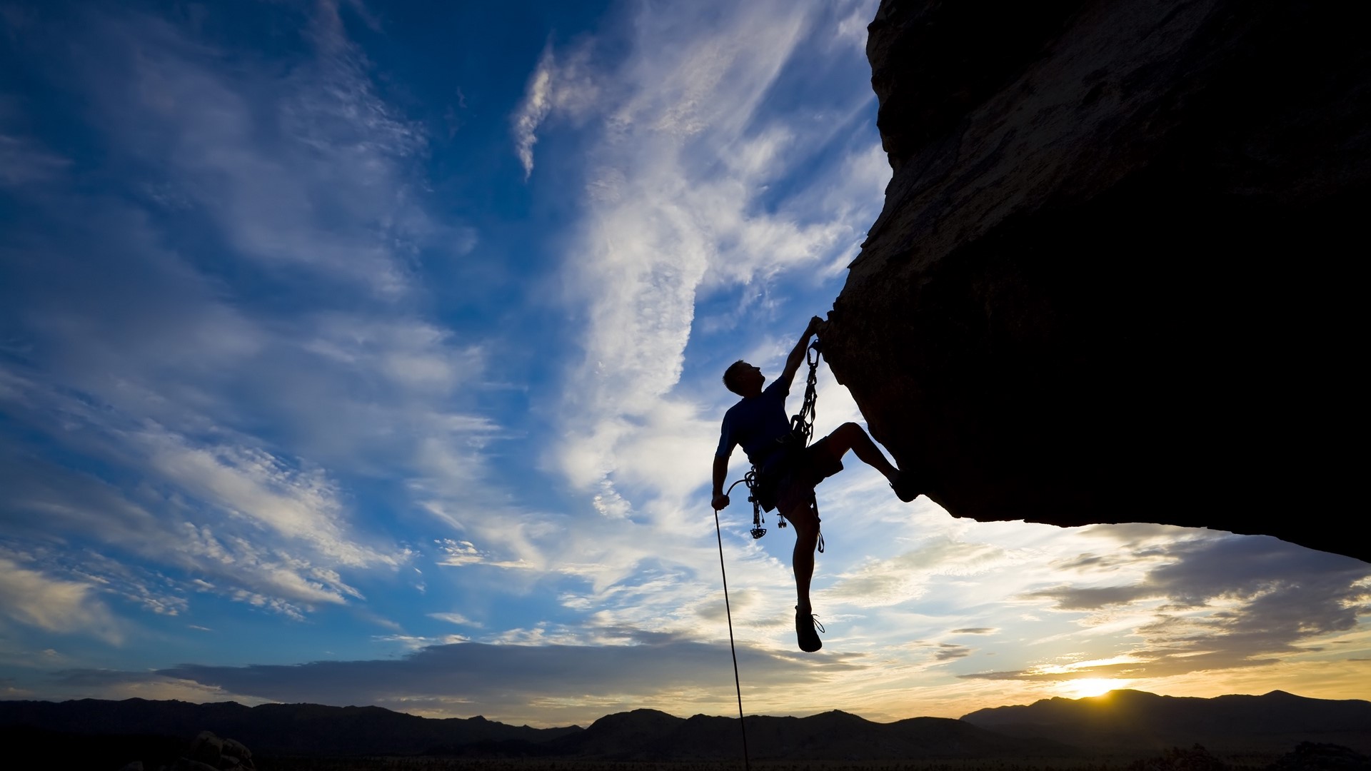 Silhouette of a rock climber at sunset HD Wallpaper