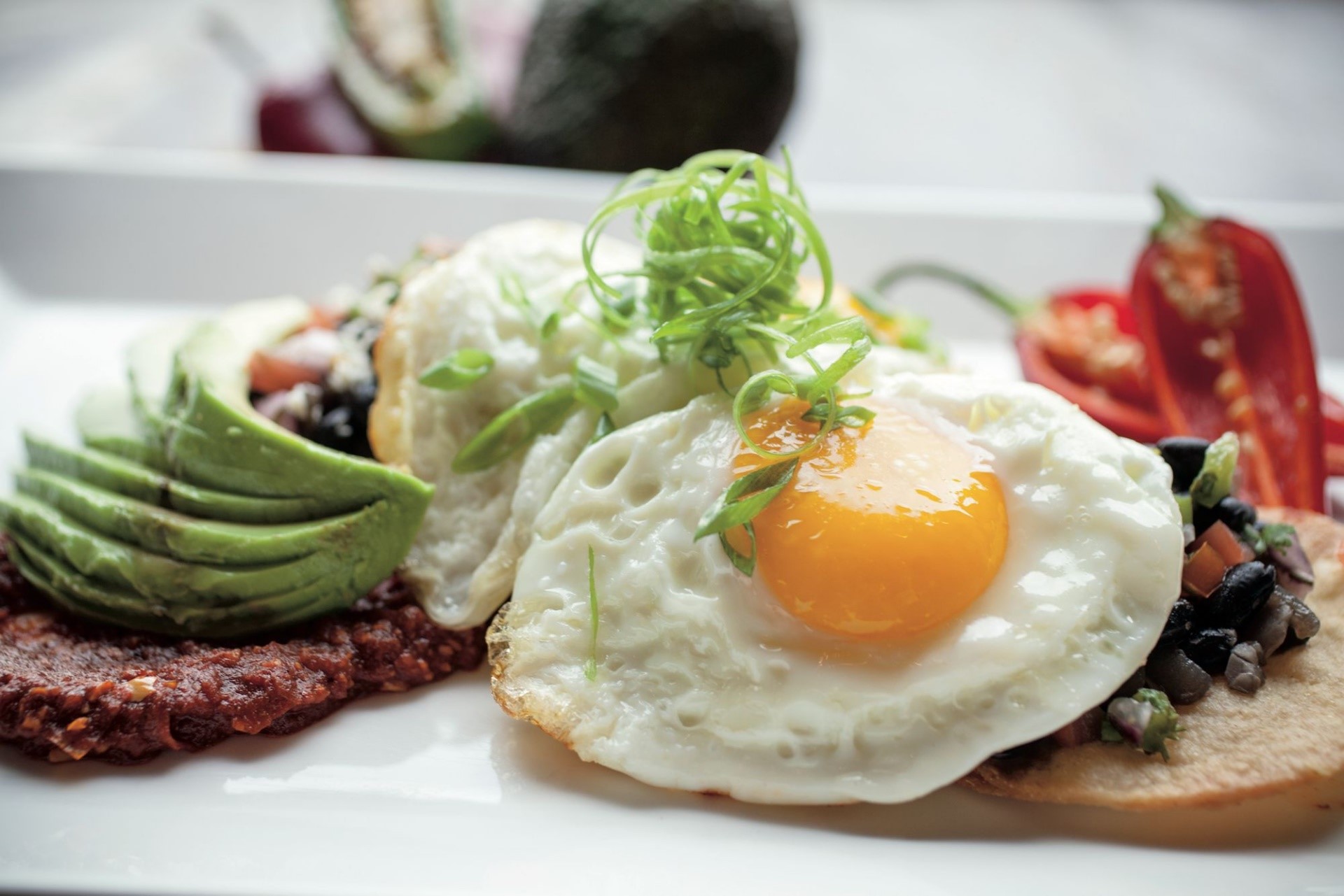 Fried eggs with avocado and chili HD Wallpaper
