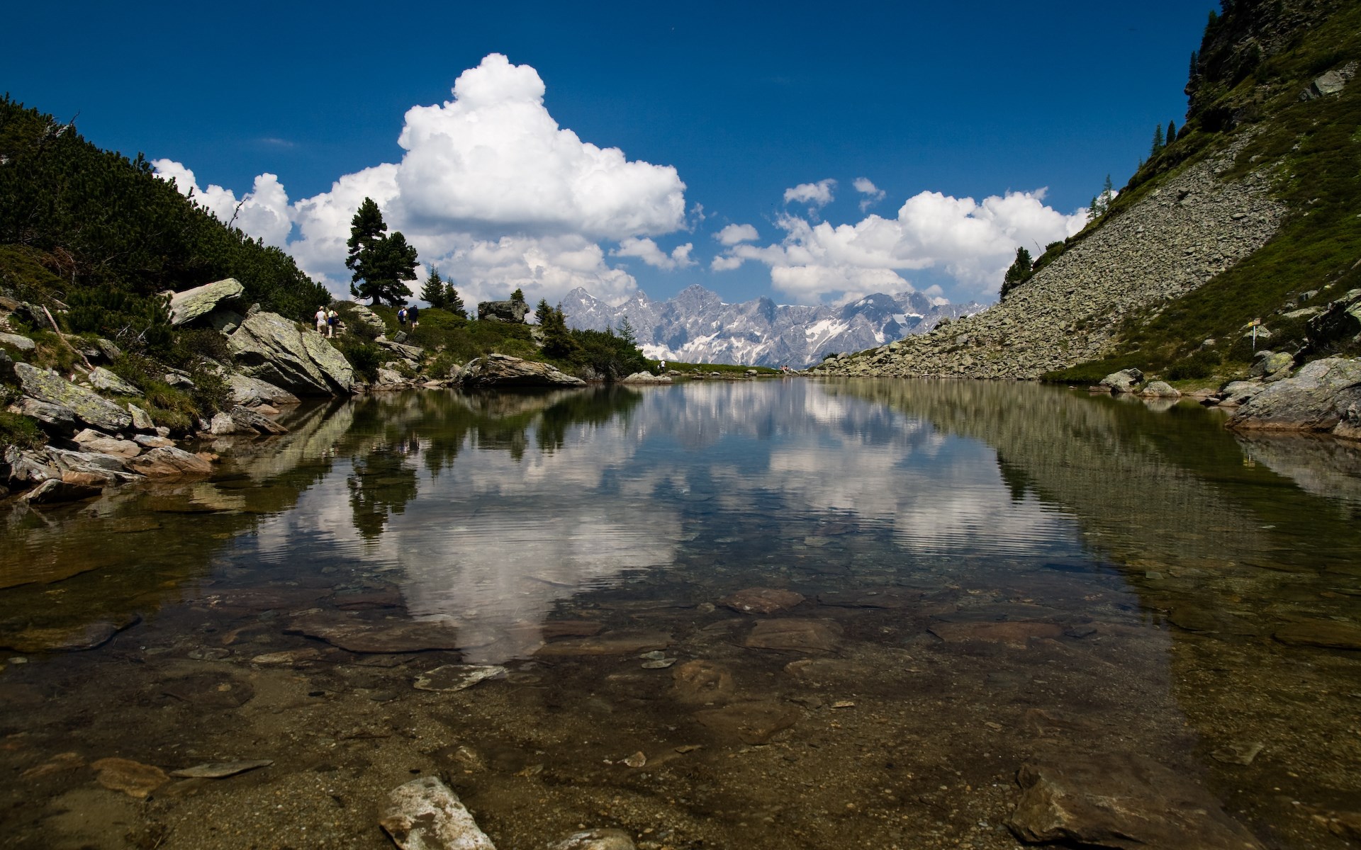 Mountain lake reflecting clouds and snow-capped peaks HD Wallpaper
