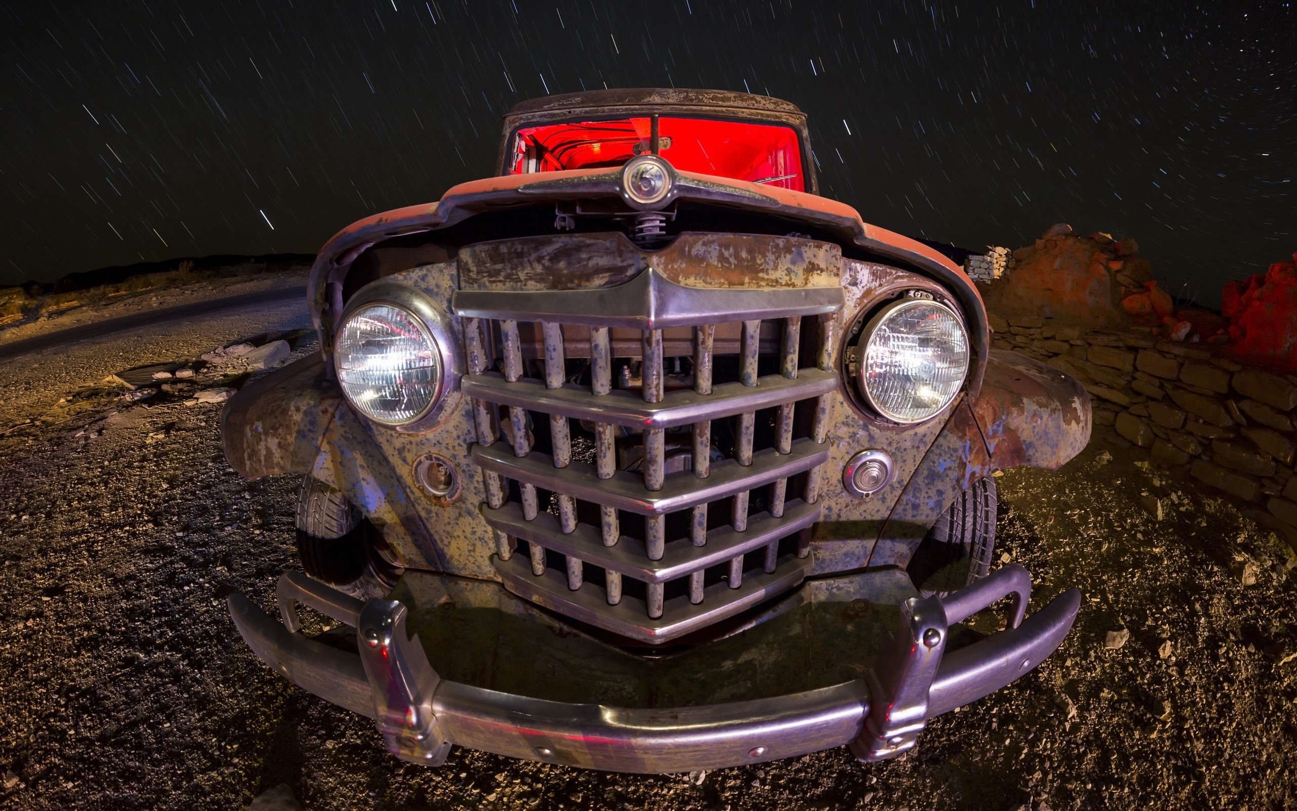 Rusty vintage car at night with star trails HD Wallpaper