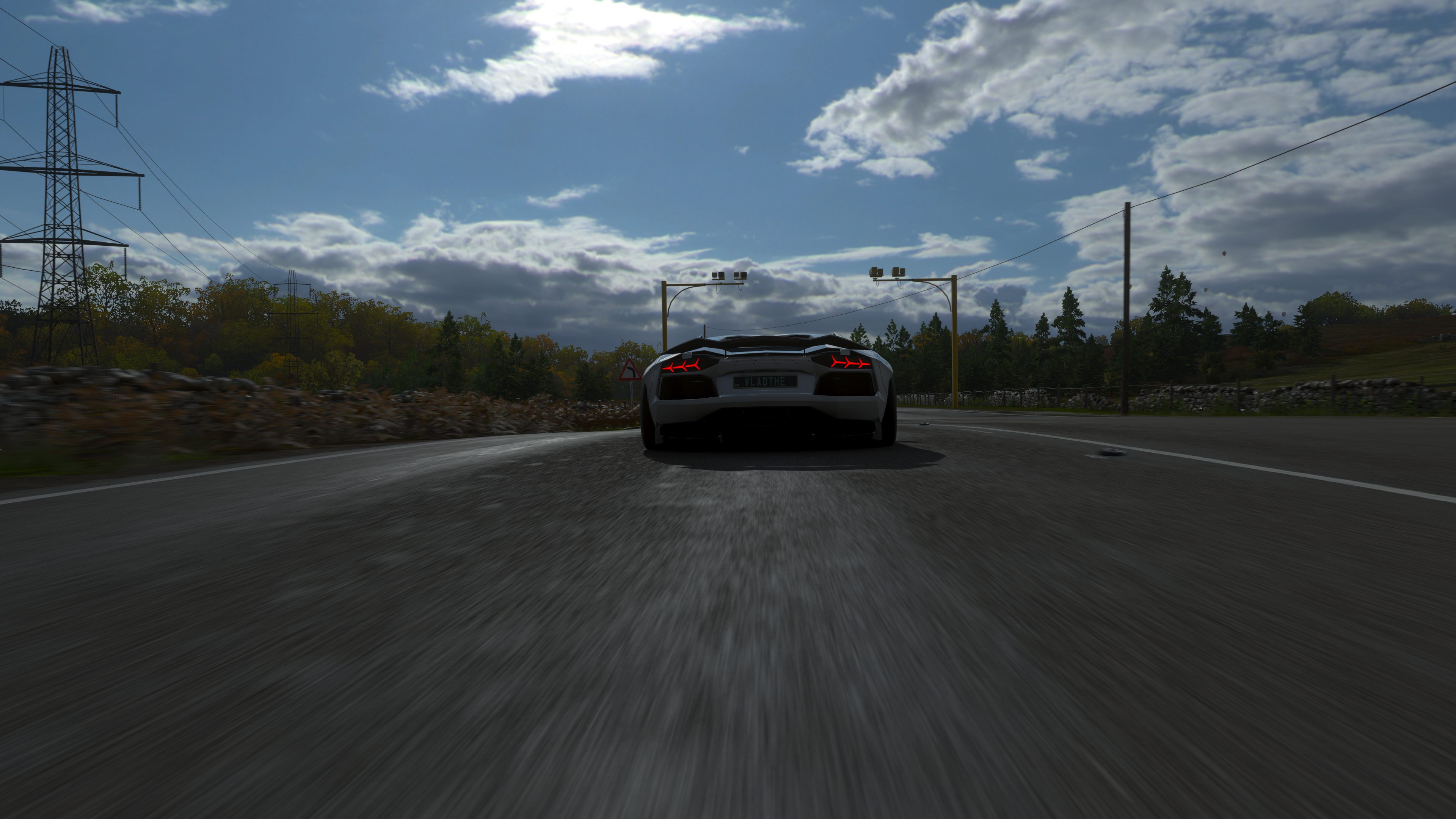 White Lamborghini Aventador driving on a road in Forza Horizon 4 HD Wallpaper